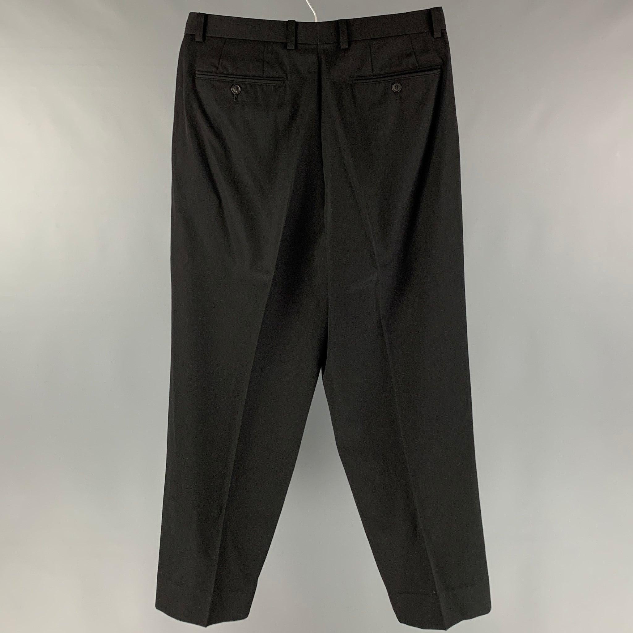 ISSEY MIYAKE dress pants comes in a black wool featuring a pleated style, and a zip fly closure. Made in Japan.Excellent Pre-Owned Condition. 

Marked:  S 

Measurements: 
 Waist: 32 inches Rise: 12 inches Inseam: 29 inches Leg Opening: 18 inches 
