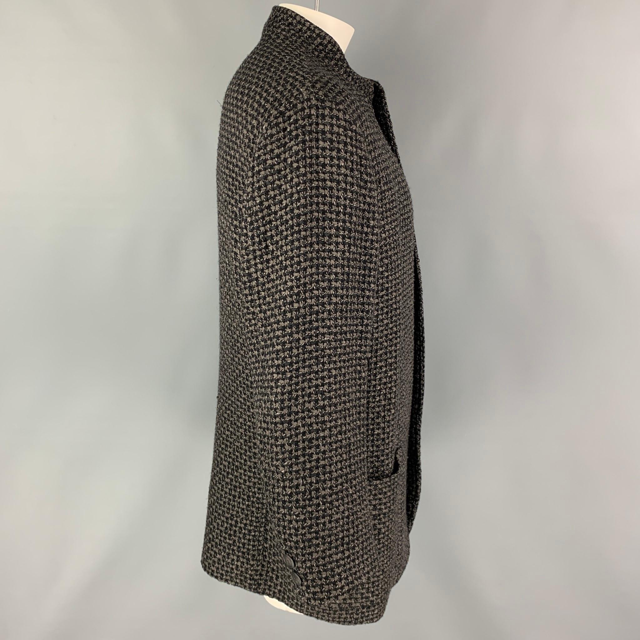 ISSEY MIYAKE MEN coat comes in a grey & black knitted wool blend featuring a collarless style, front pocket, and a buttoned closure. Made in Japan. 

Very Good Pre-Owned Condition.
Marked: XL

Measurements:

Shoulder: 20 in.
Chest: 42 in.
Sleeve: 24