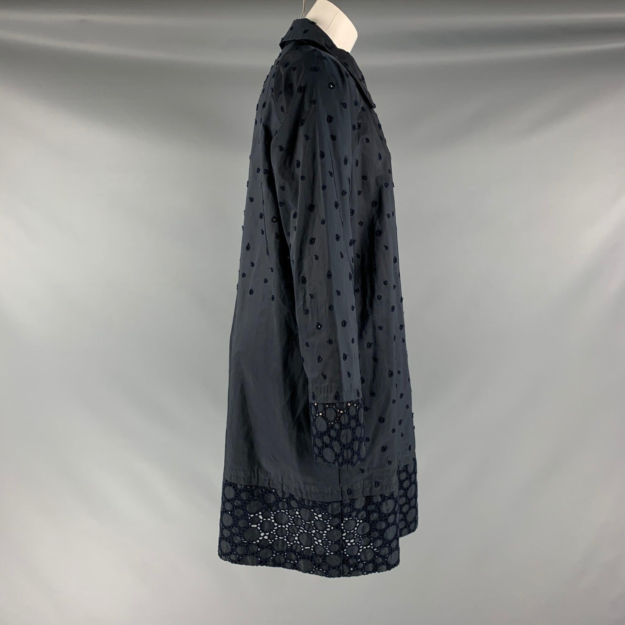 ISSEY MIYAKE HEART trench coat comes in a navy polyester eyelet woven featuring a slit pockets, eyelet texture,and a double breasted closure. Made in Japan.Excellent Pre-Owned Condition.  

Marked:   XL 

Measurements: 
 
Shoulder: 18.5 inches Bust: