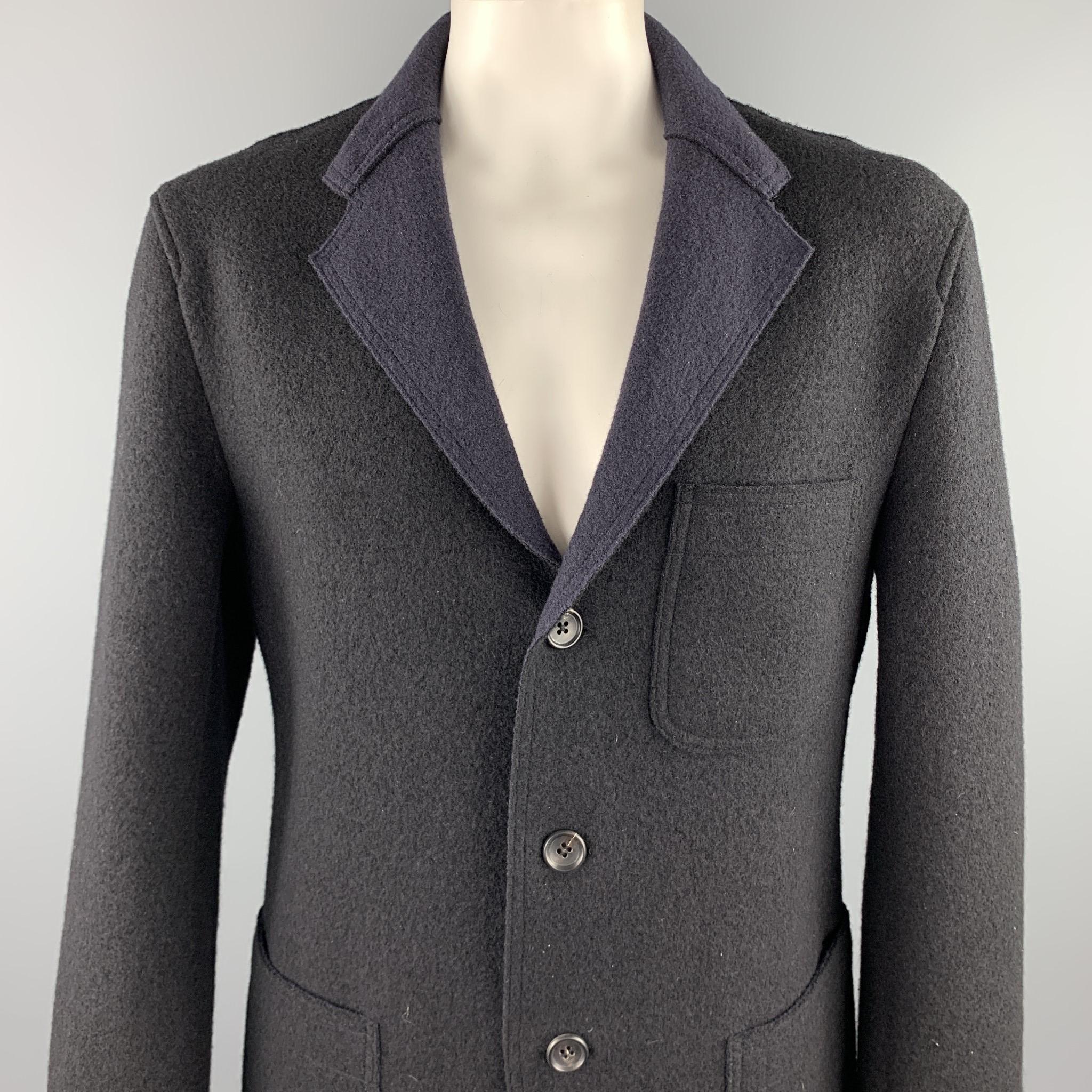 ISSEY MIYAKE coat comes in a navy textured wool featuring a notch lapel, patch pockets, and a three button closure. Made in Japan.

Excellent Pre-Owned Condition.
Marked: No size marked

Measurements:

Shoulder: 20 in. 
Chest: 46 in. 
Sleeve: 27.5