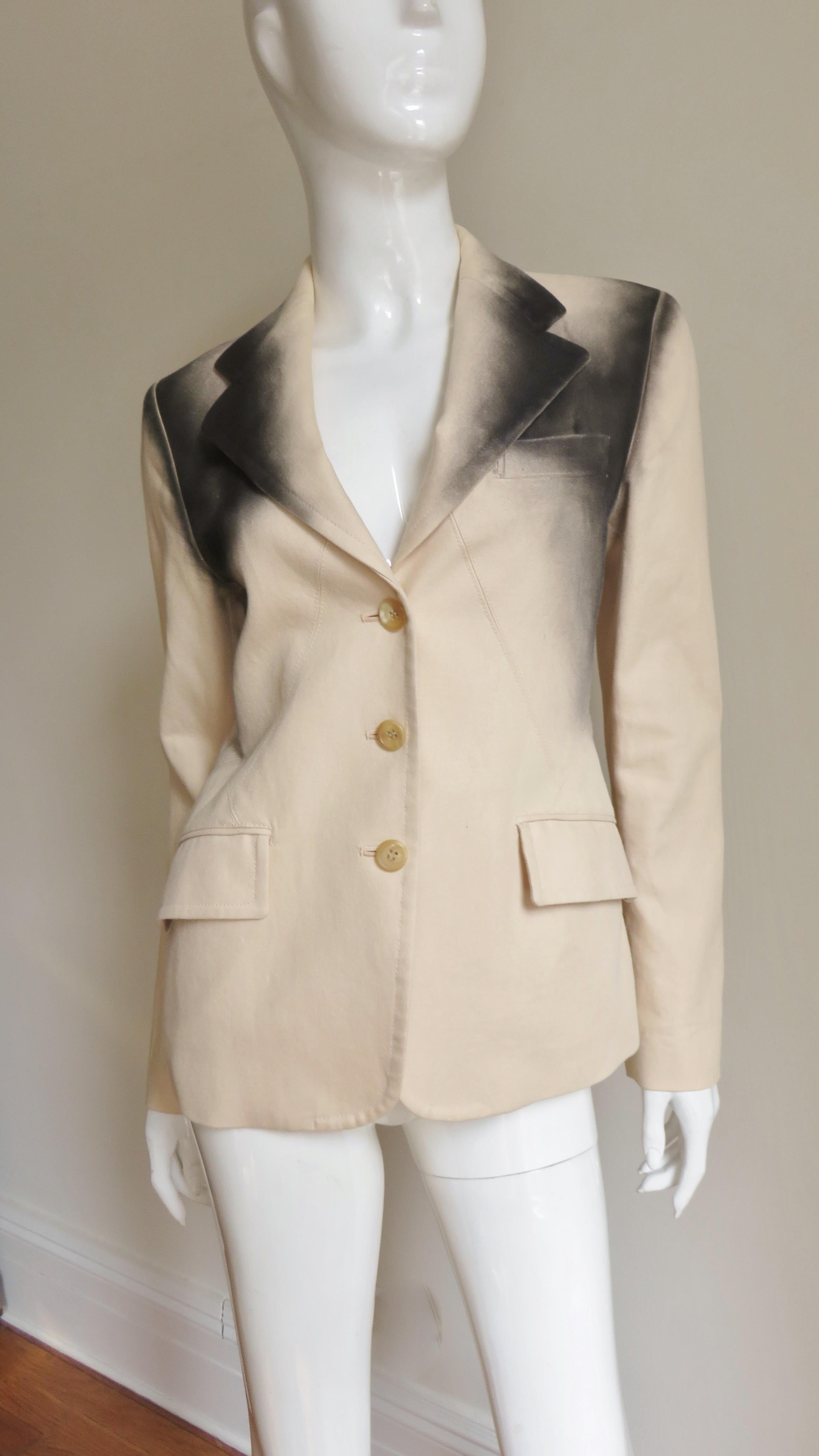 A fabulous beige cotton jacket from Issey Miyake. It is blazer style with a lapel collar, small shoulder pads, front hip flap pockets and matching front button closure. It is set apart by the intricate triangular waist seaming front and back plus