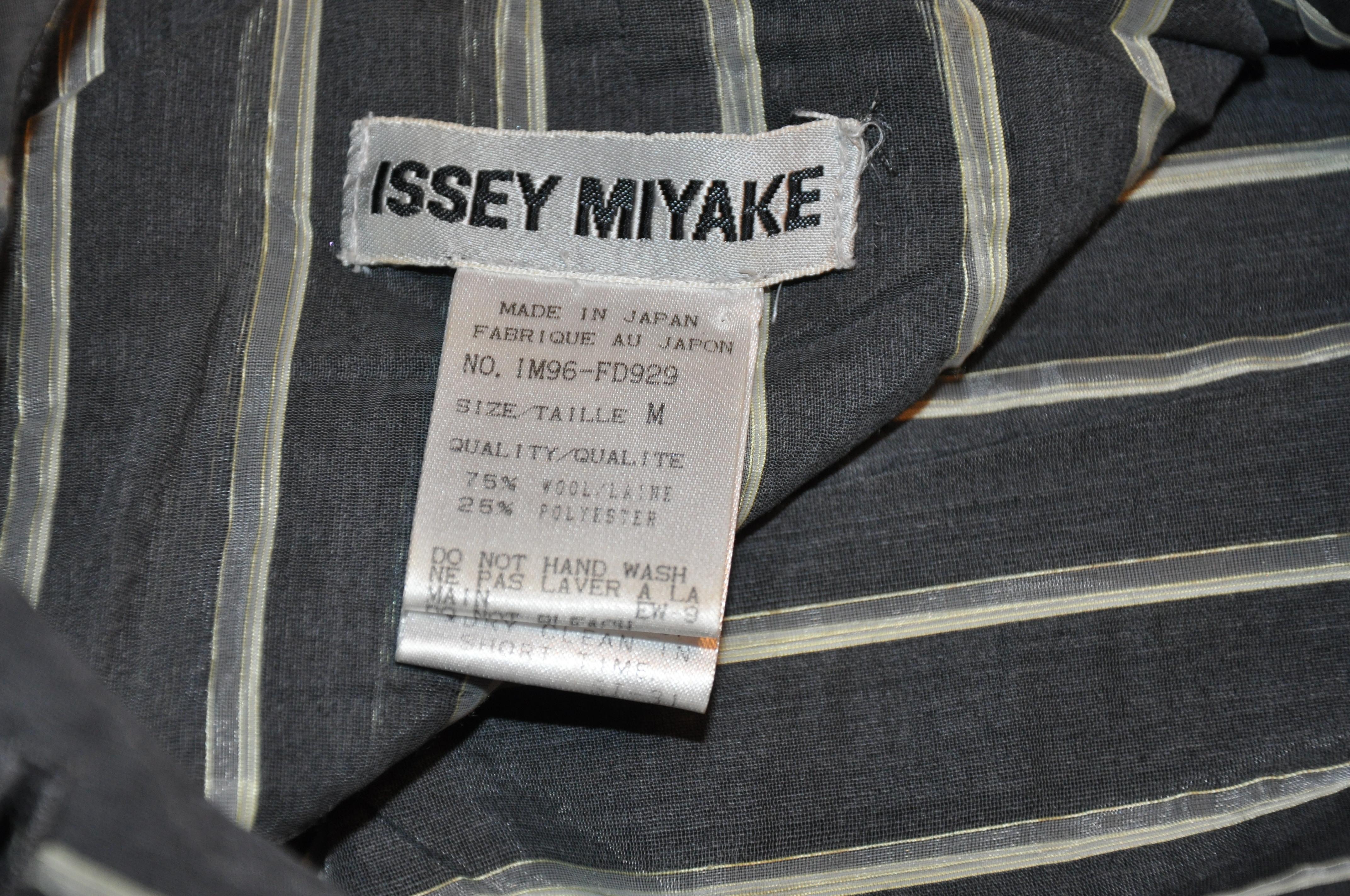 Issey Miyake wonderful sheer steel-gray linen-like painter's coat is actually a wool blend of 75% wool and 25% Polyester. Yet the feel and appearance is Linen-like. The 6-button front is accented with three patch pockets with a single-button closing