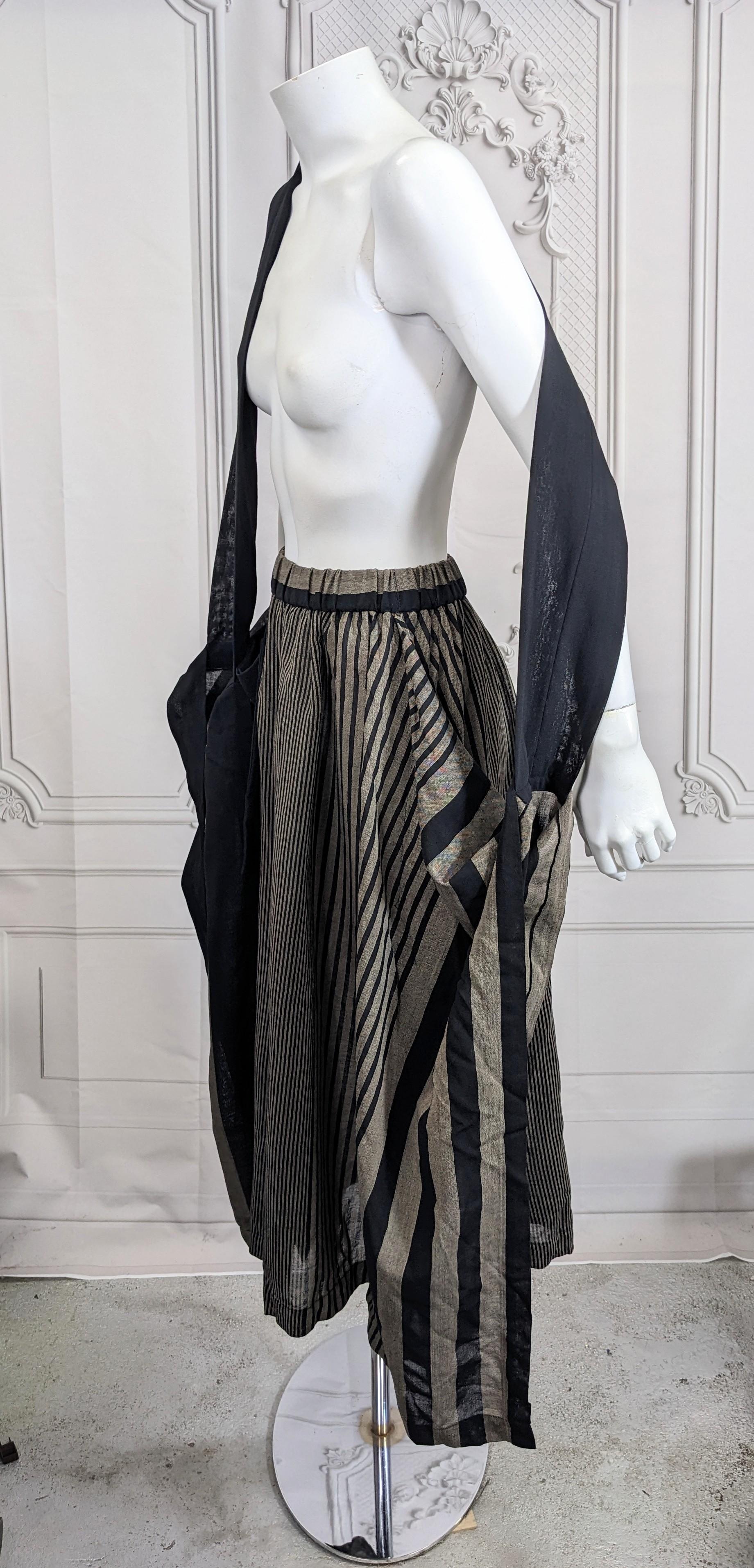 Unusual Issey Miyake Striped Wool Transformable Skirt with attached strap to use as desired. The skirt is basically a doubled over rectangle with a hole at center for waist. There is a wide black wool strap is attached to each end of the fold