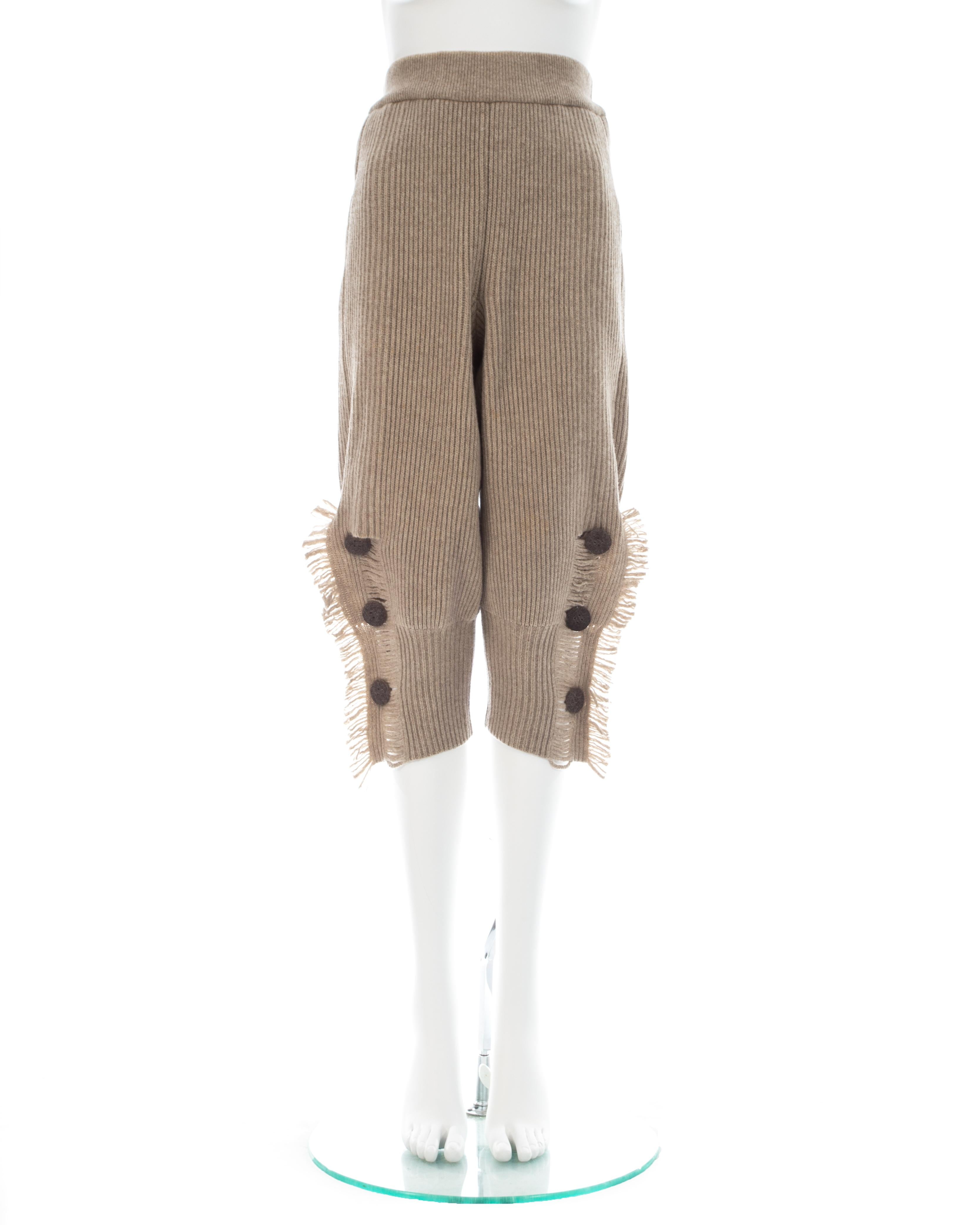 Issey Miyake; Taupe rib knit wool shorts with elastic waistband and fringed side vents

Fall-Winter 1988