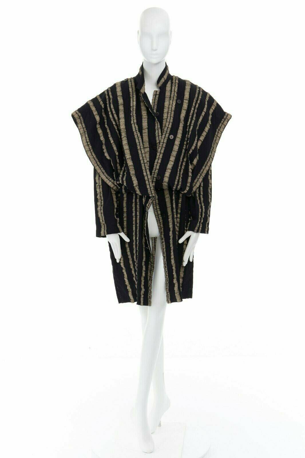 ISSEY MIYAKE Vintage 1980s black gold striped samurai shoulder wool coat M US8 
Reference: TGAS/A01064 
Brand: Issey Miyake 
Material: wool 
Color: Black 
Pattern: Striped 
Closure: Button 
Extra Detail: 100% wool. Black beige vertical stripes.