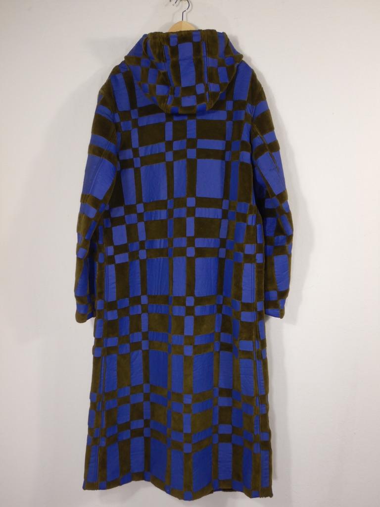 Issey Miyake heavy dark green fleece hooded coat with blue contrast panel detail. I believe this is from 1997. Button front. This is quite a heavy garment.

There are no issues such as staining or holes but the blue panels show cracking and