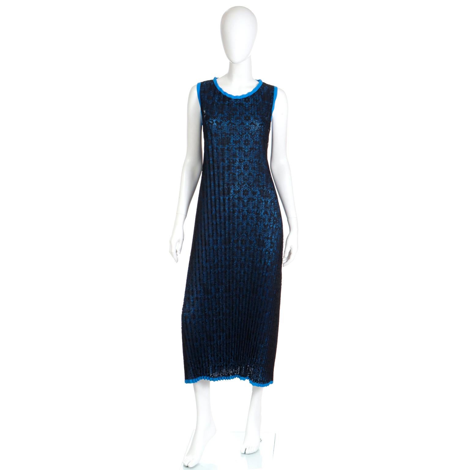 This vintage Issey Miyake full length pleated black lace dress is over a bright blue with the same blue trim on the hem, arm holes and neckline. We acquired this dress from an Issey Miyake collector who lived in Japan for many years. This particular