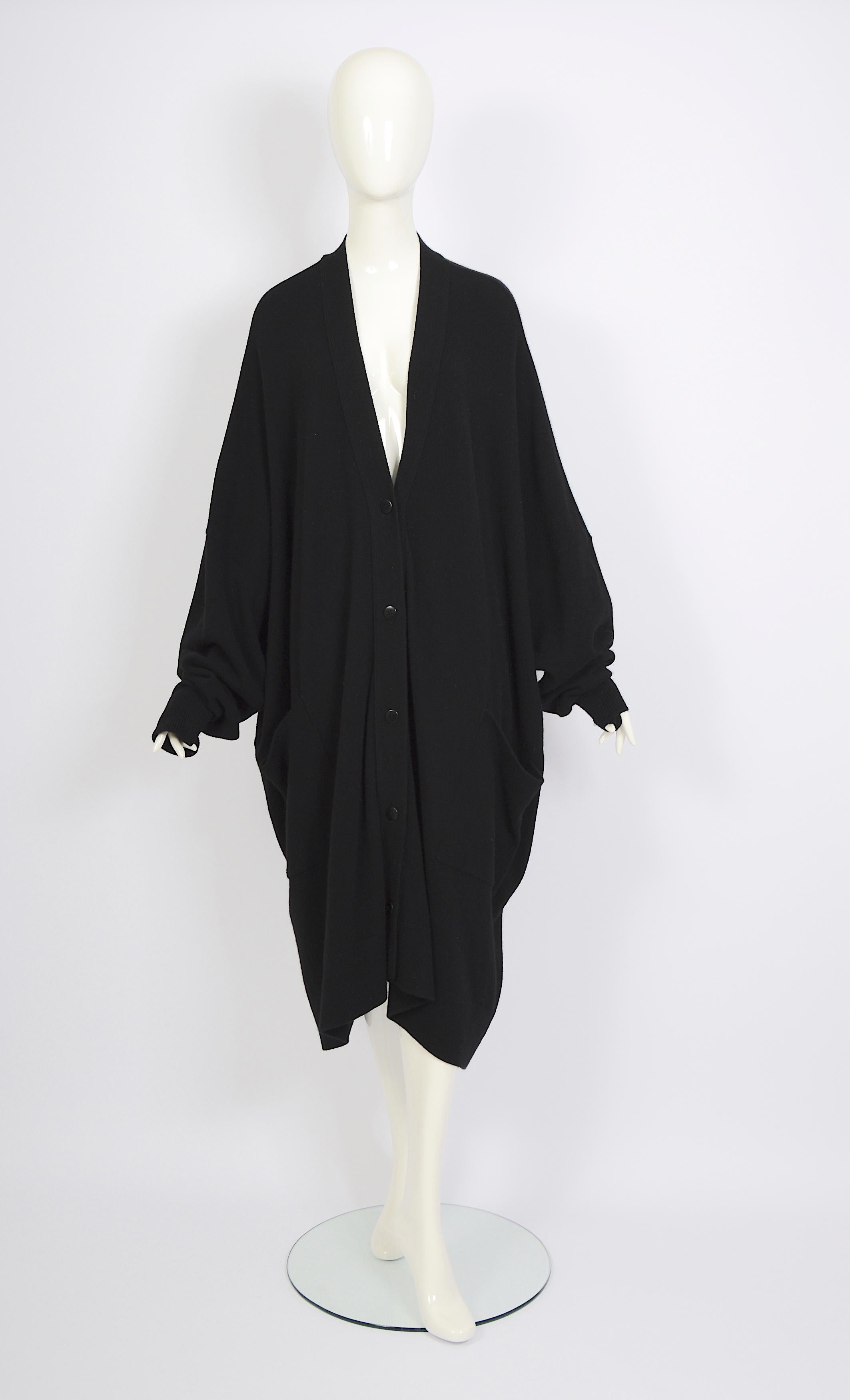 We are delighted to present this stunning vintage circa 1970s Issey Miyake cocoon cardigan it is oversized/huge with a plunging neckline, dolman sleeves, pockets, and a single button closure at the front.
This Issey Miyake piece is stunning. It