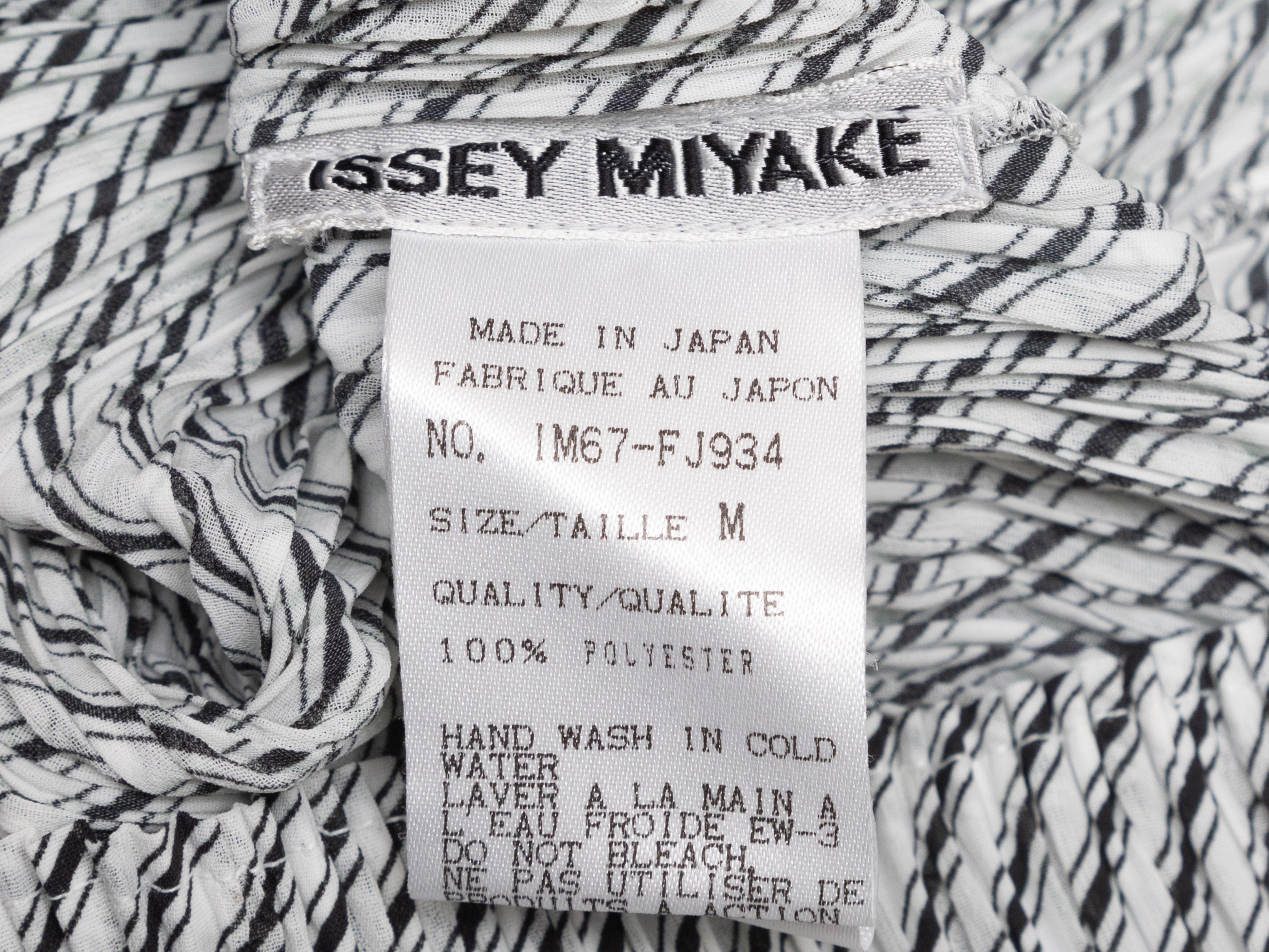 Product Details: White and black striped plisse sleeveless top by Issey Miyake. Scoop neckline. 28