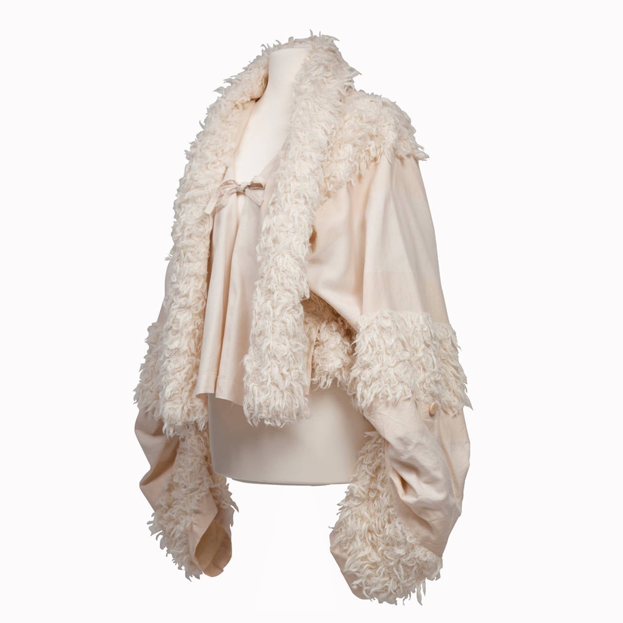 Incredible Issey Miyake A-line cotton jacket in natural white with mohair details.
The jacket closes with bow on chest. Sleeve length adjustable.
Inside jacket has piping finishing. 
Material : cotton, wool, cupro, silk, mohair 
52 cm length from