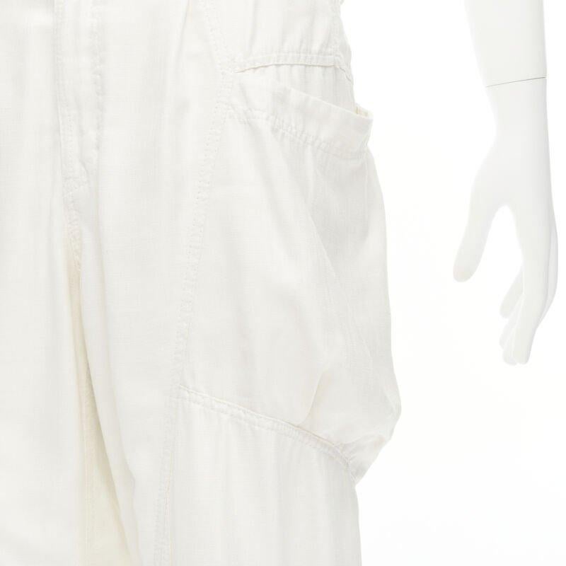 ISSEY MIYAKE white polyester cargo pocket dropped crotch parachute pants JP4 L
Reference: AEMA/A00106
Brand: Issey Miyake
Material: Polyester
Color: White
Pattern: Solid
Closure: Zip
Extra Details: Button cuffed hem. Concealed zip fly.
Made in: