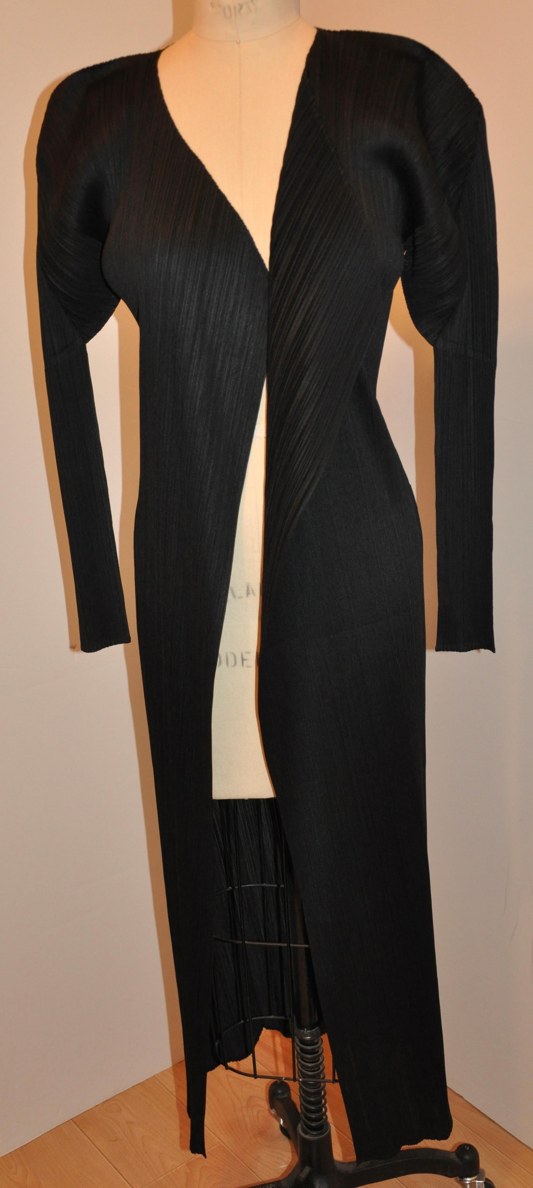    Issey Miyake wonderful iconic signature jet-black pleated open coat measures 44 in length in front and 50 inches in back. Shoulders are 17 1/2 inches across, underarm circumference is 36 inches, waist is 32 inches, hips are 36 inches, sleeves are