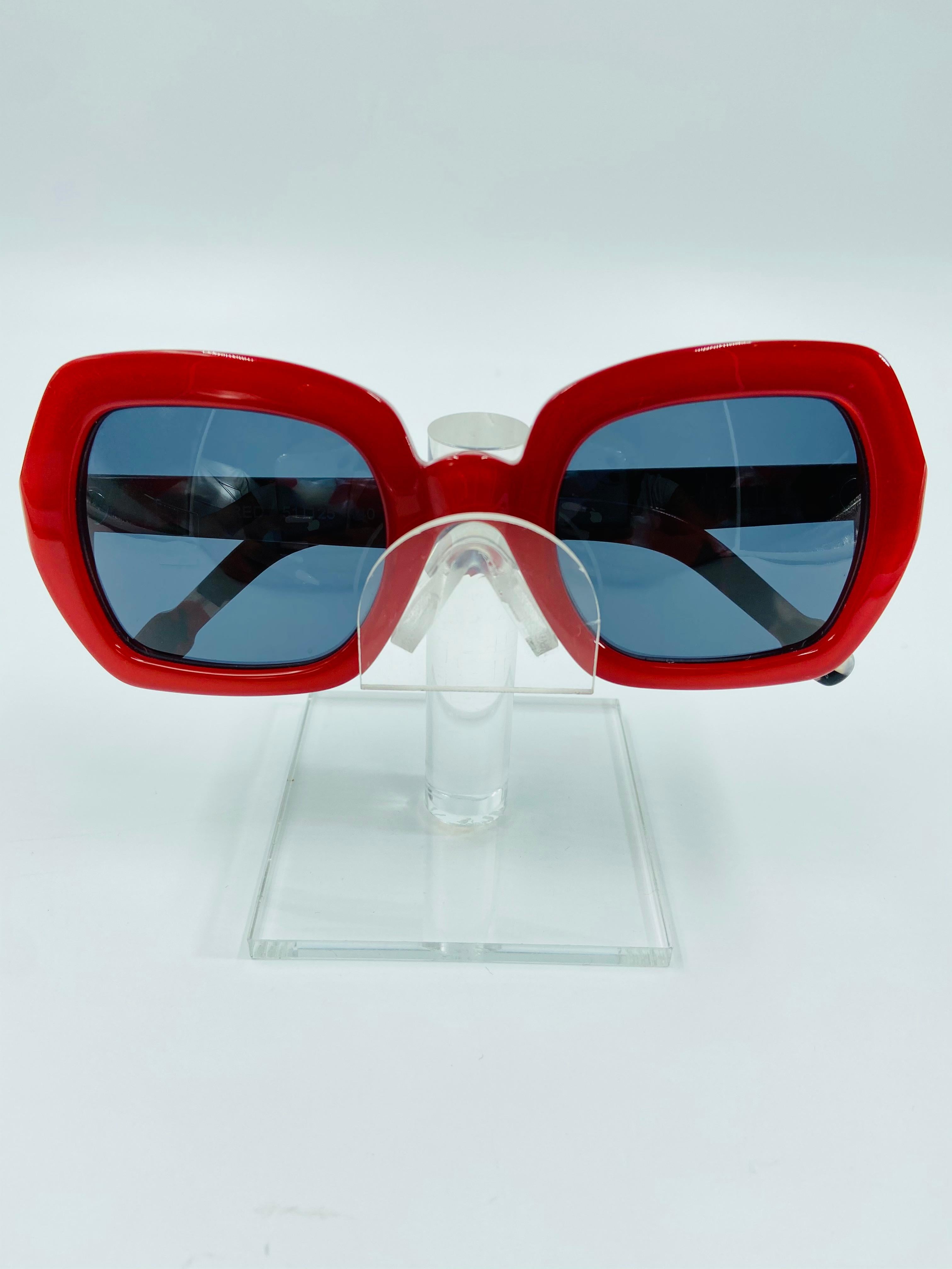 Isson Australia Vintage Ida Red Dead Stock Frames 
Marbled red, pearl and black arms
Handmade in Australia
Dark gray tinted lenses
Never worn

Max width 6 in
Lenses height 1 3/4 in.
Lenses width 2 in.
Arm length 5 1/2 in.