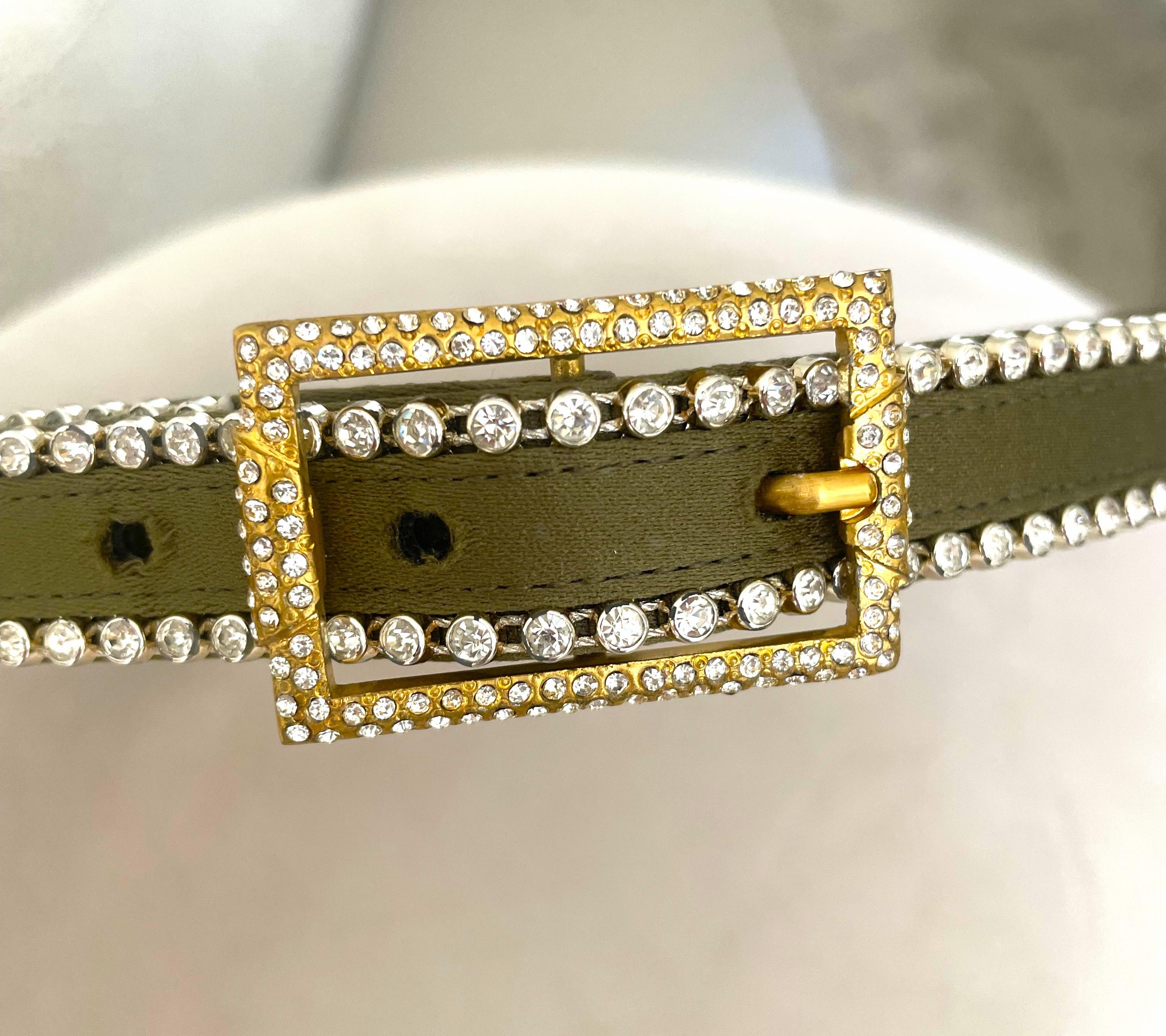 Questa rarissima cintura Istante by Versace degli anni '90, in condizioni pari al nuovo e con strass, è un pezzo lussuoso e altamente collezionabile della linea più accessibile della casa di moda italiana, Istante, creata sotto la visione di Gianni
