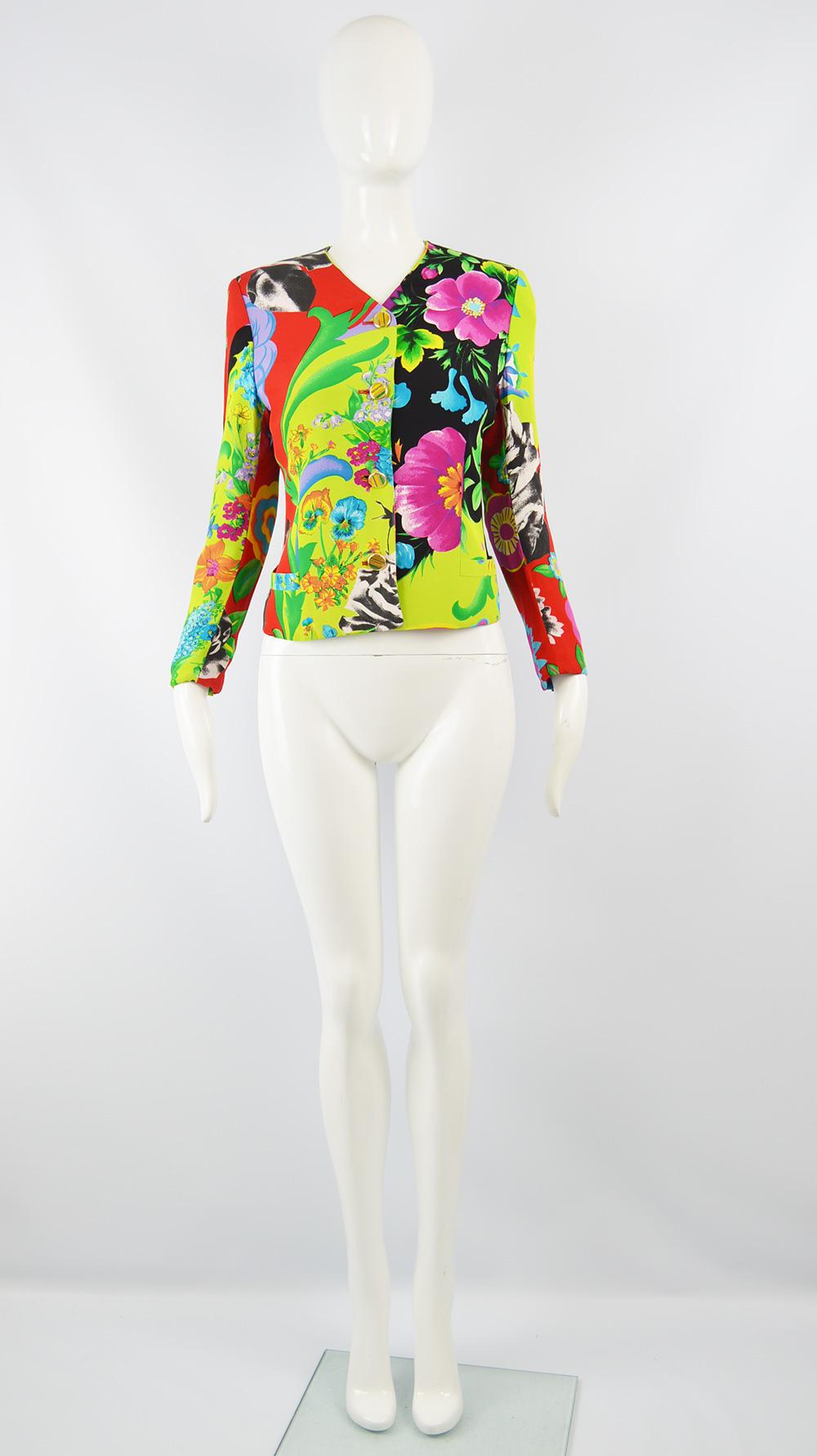 A fabulous women's vintage blazer jacket from the late 80s / early 90s by Gianni Versace for the Istante line. In a brightly multicolored fabric with a tropical floral print throughout in hues of green, black, pink, blue and red. Perfect for a bold