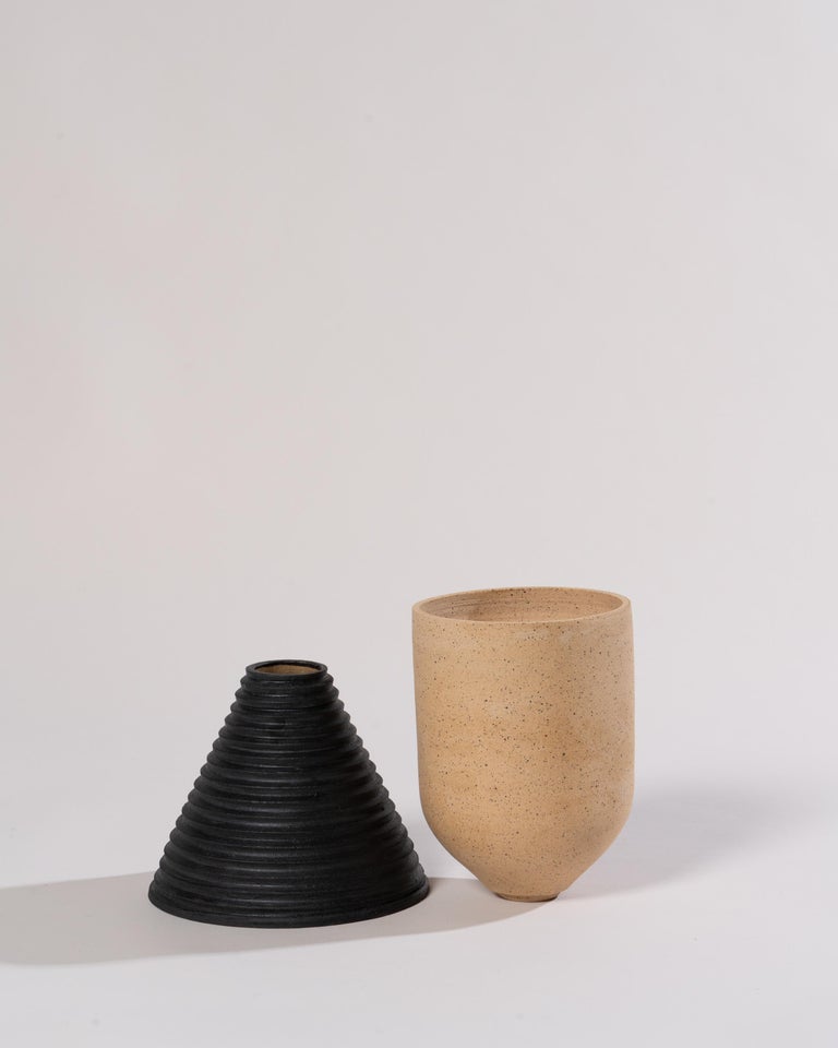 2-Part wheel-thrown planter in tan speckled stoneware with black underglaze. The upper part features a drainage hole for optimal plant health, and the glaze-lined base collects excess water.