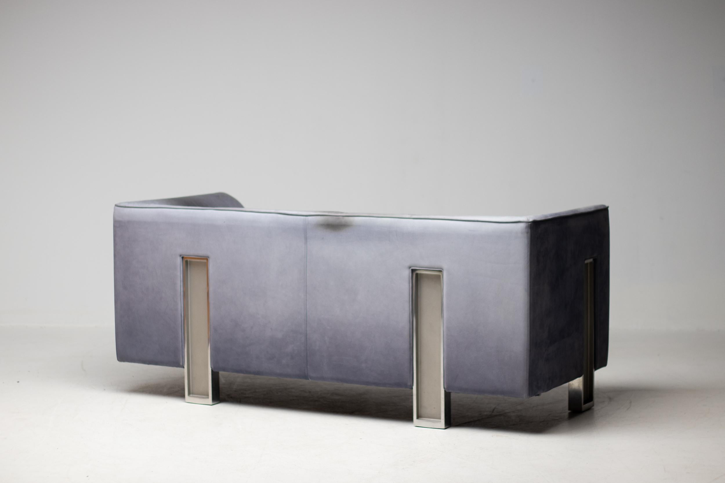 Architectural sofa designed by Japanese architect Shigeru Uchida.
This spectacular sofa with die cast aluminum legs was in production for only a short while in 1995.
The thick light blue/grey buffalo leather is patinated from 25 years of careful