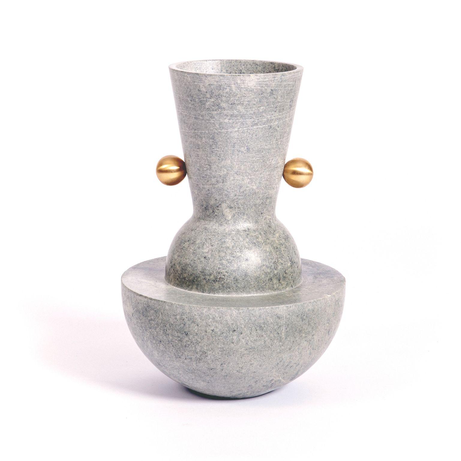 Ita 1 - Soapstone vase by Alva Design
Materials: Soapstone, brass
Dimensions: 22 (Ø) x 32 (H)

ALVA is a furniture and objects design office, formed by brothers Susana Bastos, artist and designer, and Marcelo Alvarenga, architect. Their projects