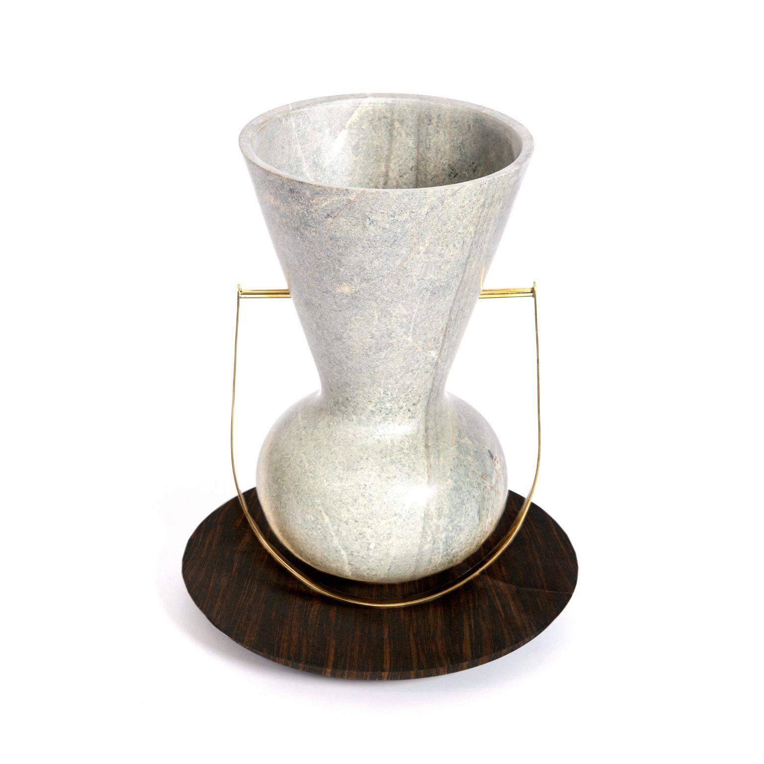 Ita 2 - soapstone vase by Alva Design
Materials: Soapstone, brass
Dimensions: 25 (Ø) x 32 (H)

Alva is a furniture and objects design office, formed by brothers Susana Bastos, artist and designer, and Marcelo Alvarenga, architect. Their projects