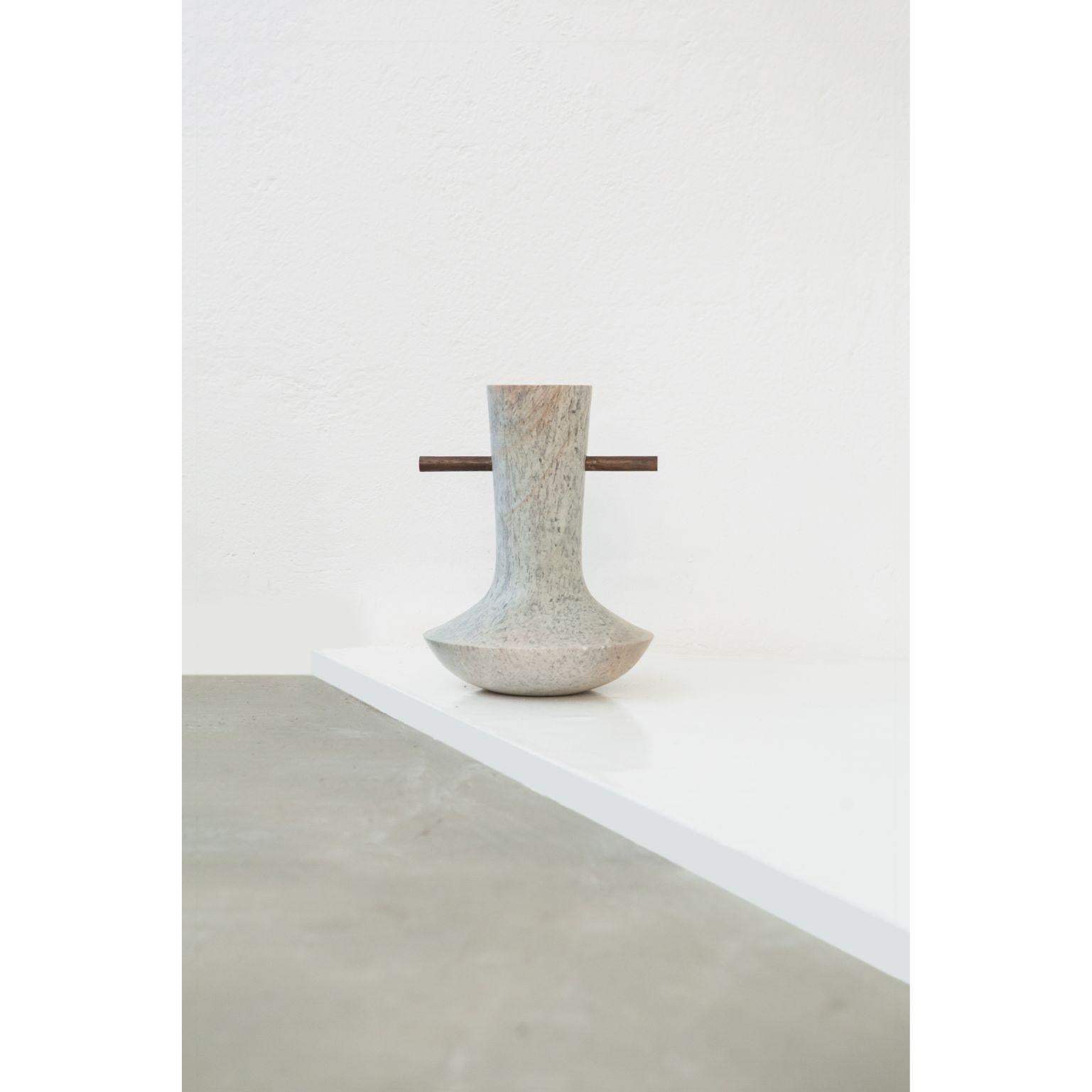 Ita 3 - Soapstone vase by Alva Design
Materials: Soapstone, solid wood,
Dimensions: 24 (Ø) x 32 (H)

ALVA is a furniture and objects design office, formed by brothers Susana Bastos, artist and designer, and Marcelo Alvarenga, architect. Their