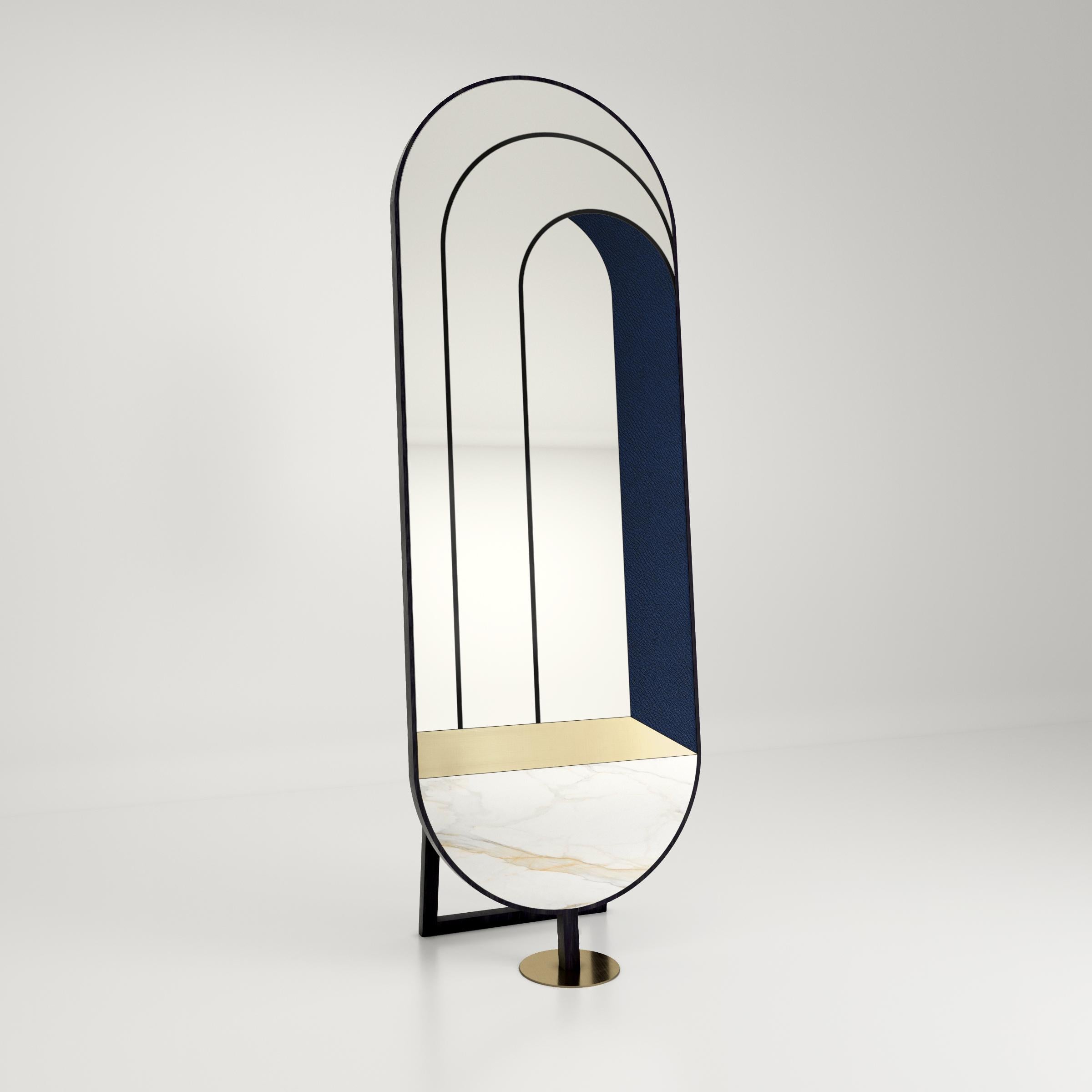 Specchio da terra Itaca di Atlas Project
Dimensioni: P 35 x L 58 x H 175 cm. 
Materiali: Ferro verniciato a polvere nero, marmo Calacatta Gold, ottone spazzolato, specchio, pelle blu e legno. 

ITACA
A door that leads to infinite others. Le