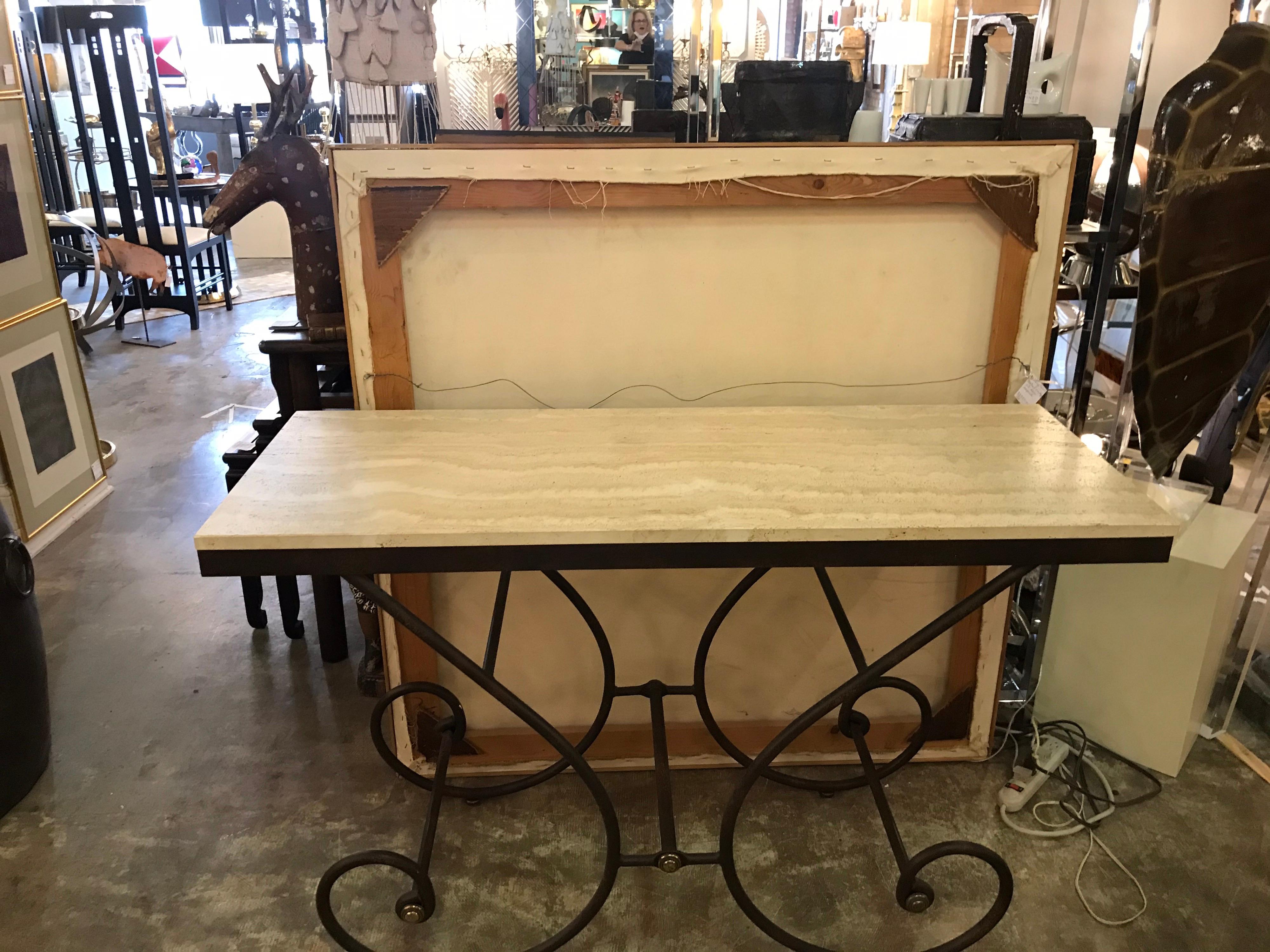 This is a lovely heavy iron with brass caps scroll table with travertine stone thick top. Made in Italy probably, circa 1980.
  