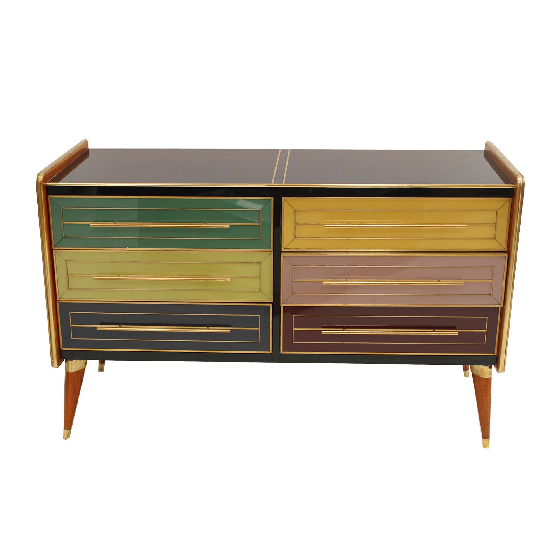 Stunning mid-century Italian sideboard with a striking design from the 1950s. This exquisite piece features a solid wood structure, elegantly covered with colored glass panels that bring a vibrant and sophisticated touch to any interior. With 6