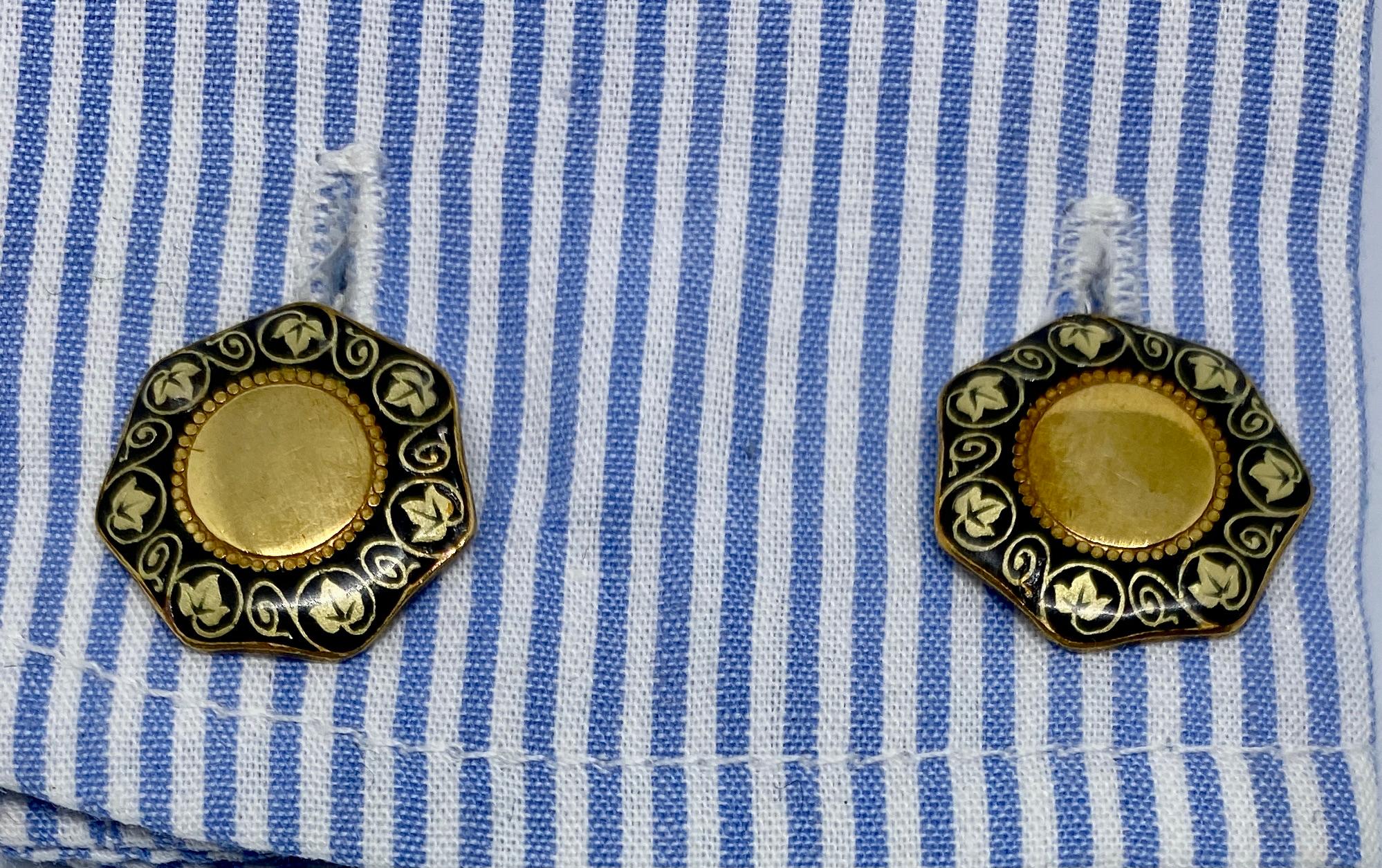 An exceptional pair of double-sided cufflinks in the Italia Liberty taste, as the Art Nouveau movement was known in Italy. The unusual, heptagonal (7-sided) faces feature black and pale green enamel borders depicting ivy vines and leaves. 

These