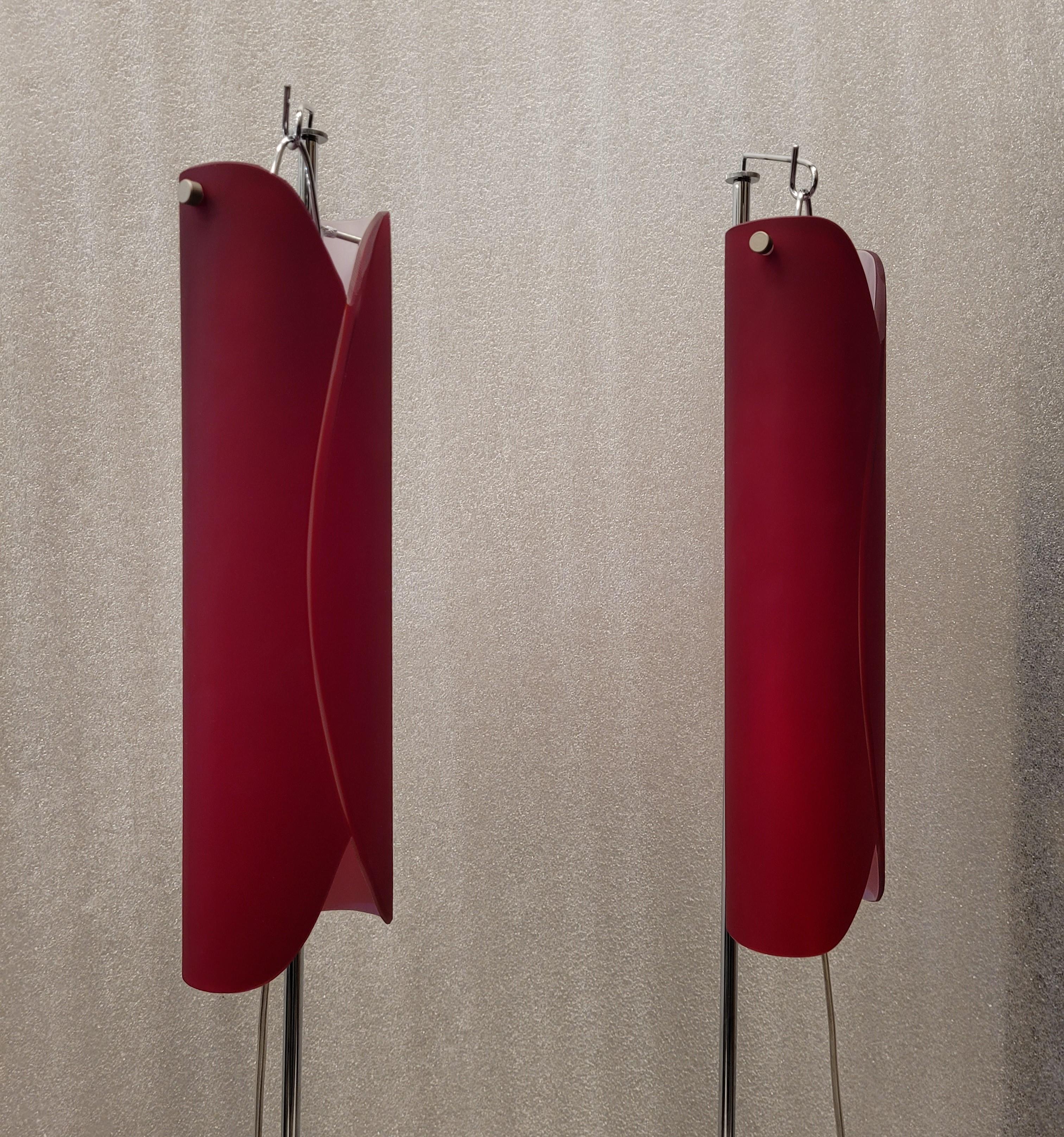 Outstanding pair of Floor lamps in steel and red Murano glass made by the Vivarini factory for Roche Bobois. Exquisite in its conception and structure, the screen is made of curved glass, red on the outside and white on the inside, in the shape of a