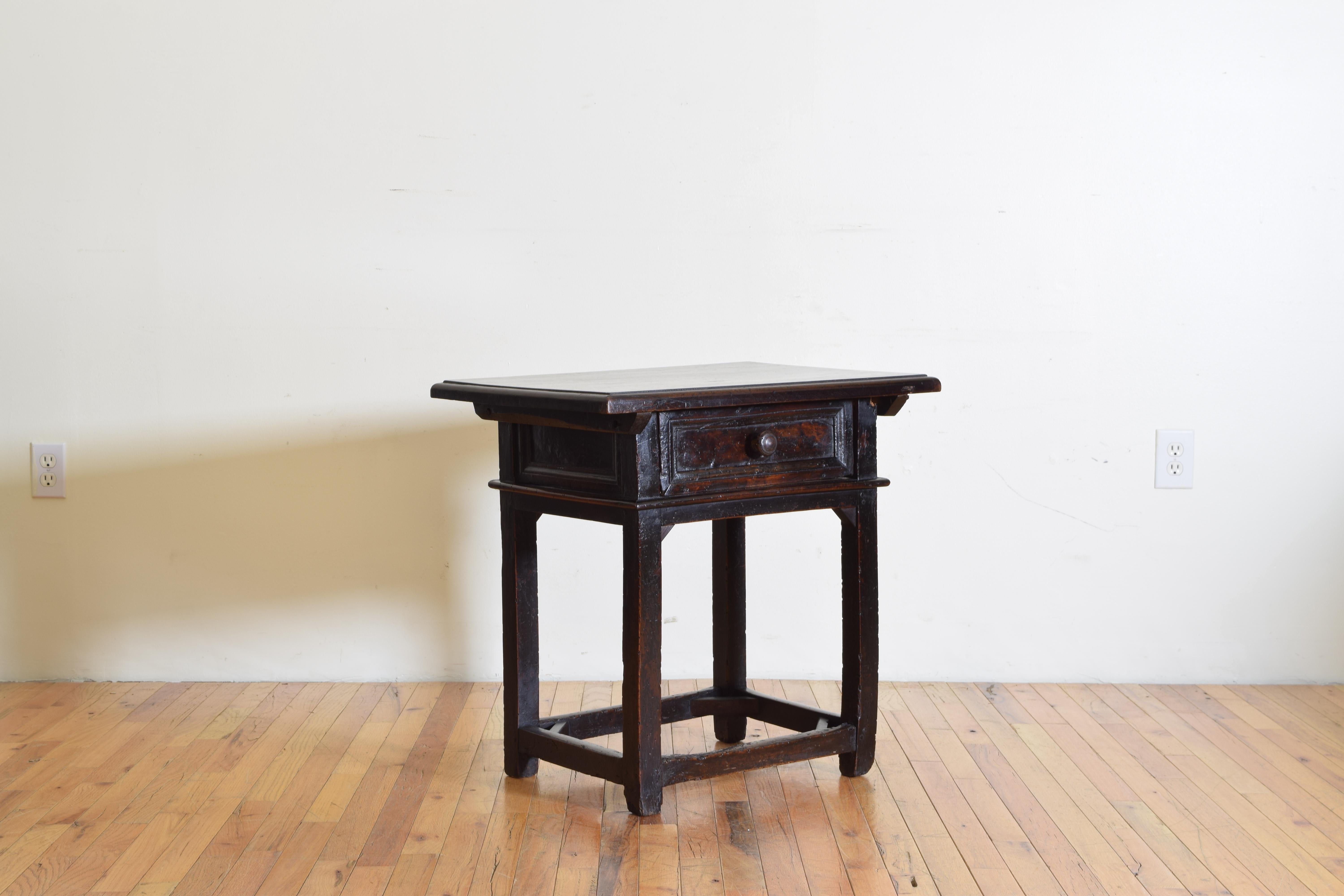 The rectangular top with molded edge above a case housing one drawer and having paneled sides, raised on straight legs joined by a box stretcher with open corner bracing, this type of low table was typically used for working on small objects or
