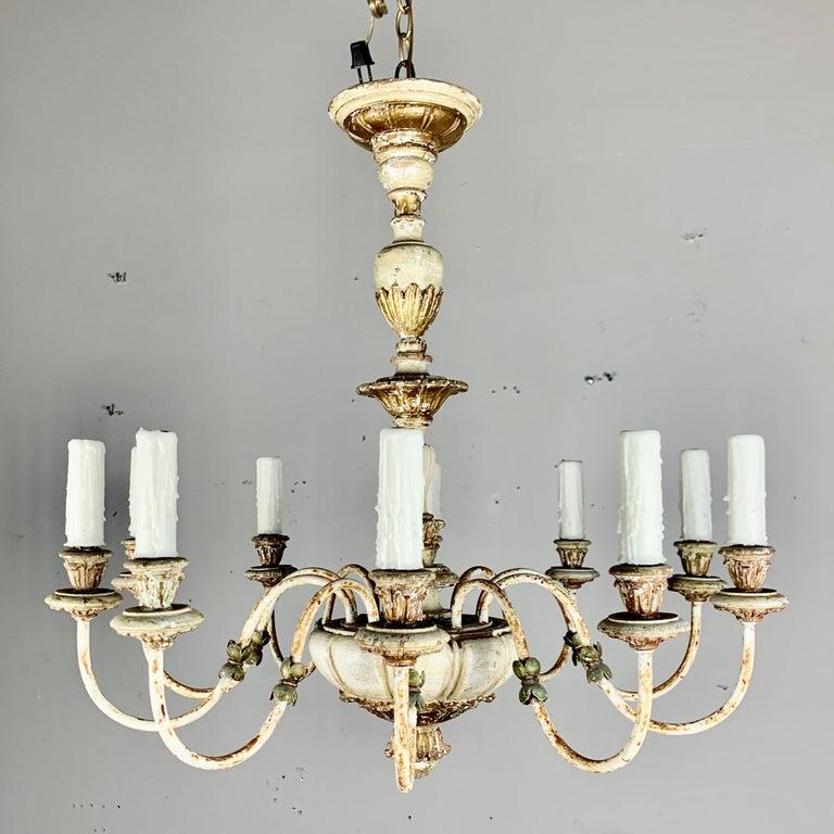 Italian painted ten light chandelier in wood and iron. The fixture is newly rewired with drip wax candle covers and includes chain and canopy.