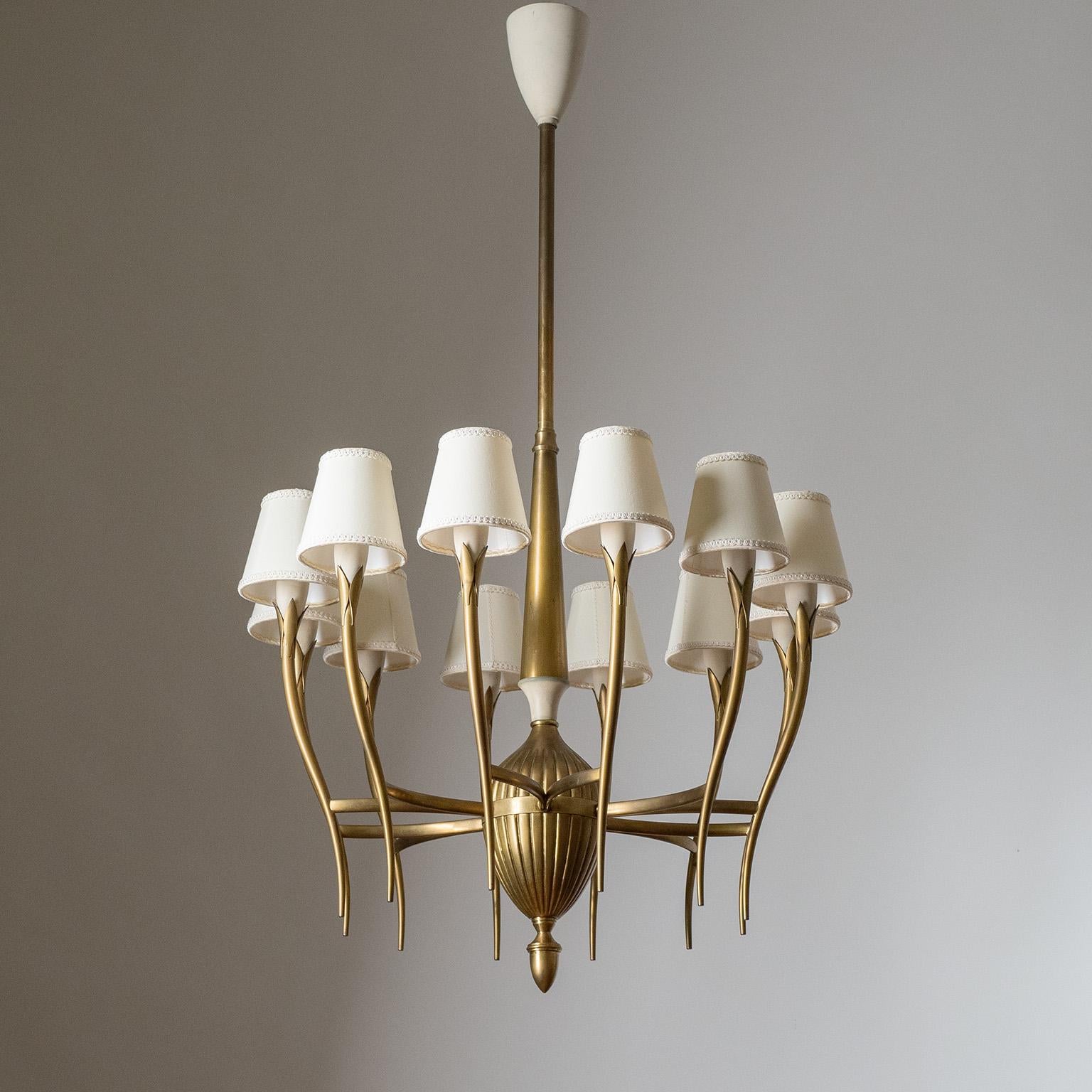 Rare Italian brass chandelier from the 1940-1950s. Twelve slender and sensuously curved brass arms with a satin finish and off-white lacquered socket covers. Original brass E14 sockets with new wiring and custom shades.

Measures: Height 102cm