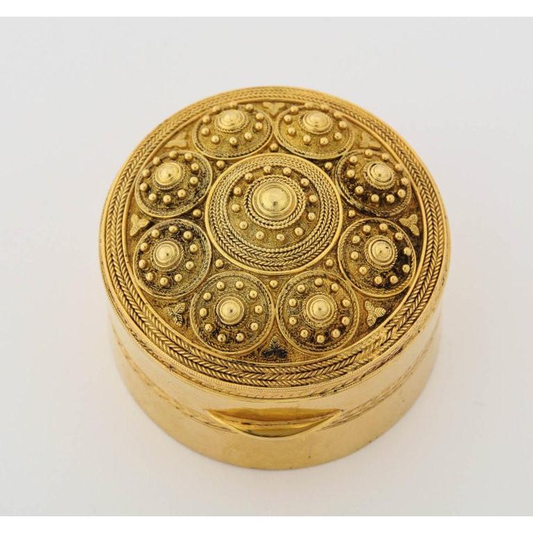 An Italian 14-karat gold round box Bomboniere, in the Archaeological style, circa 1880.  Very fine quality.  Circular and with hinged lid decorated in the Scythian manner with beading and fine rope twist concentric circles, the sides and bottom