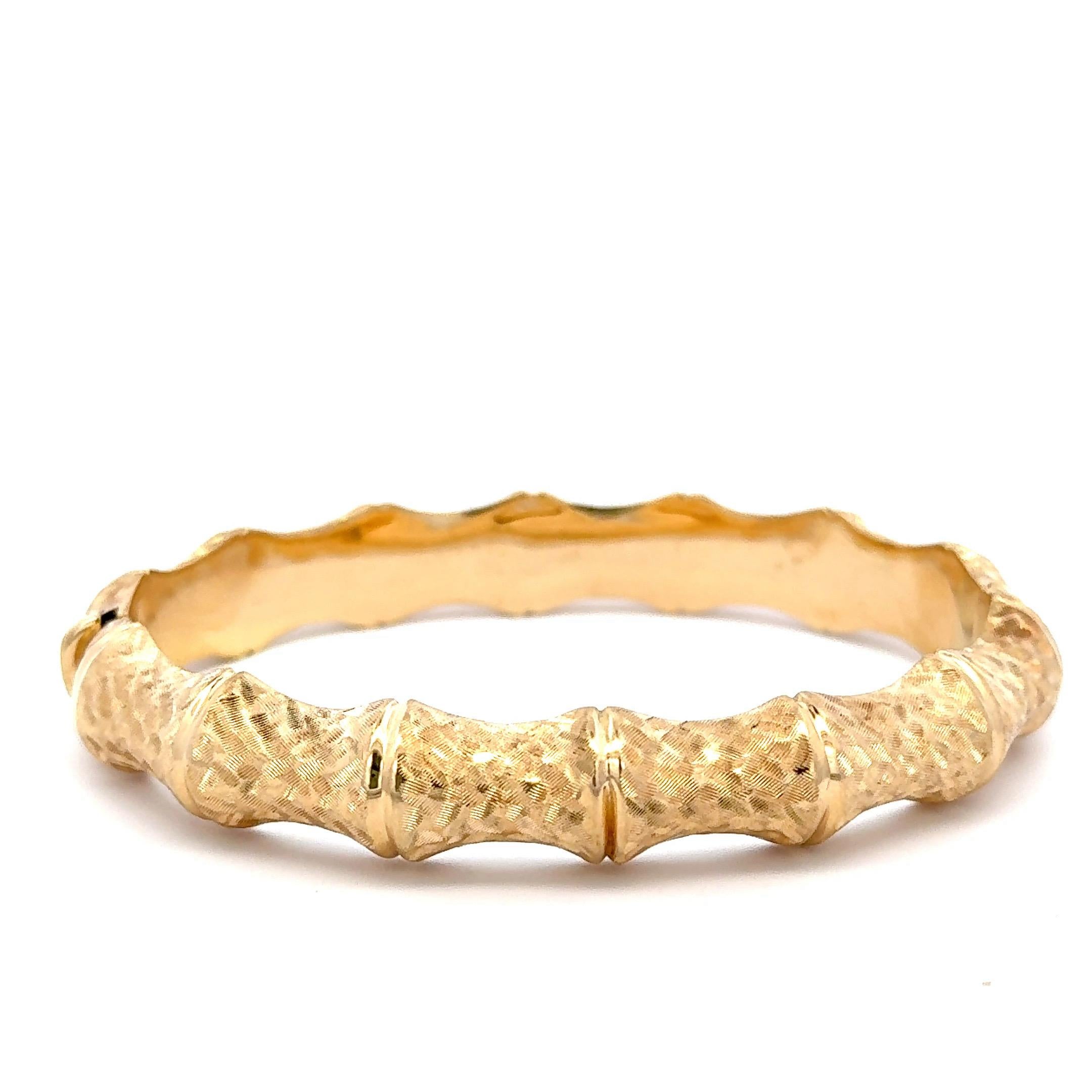 Made in Italy, this 14 karat yellow gold bangle features a bamboo motif weighing 17.1 grams. 
Fits a standard size wrist. 