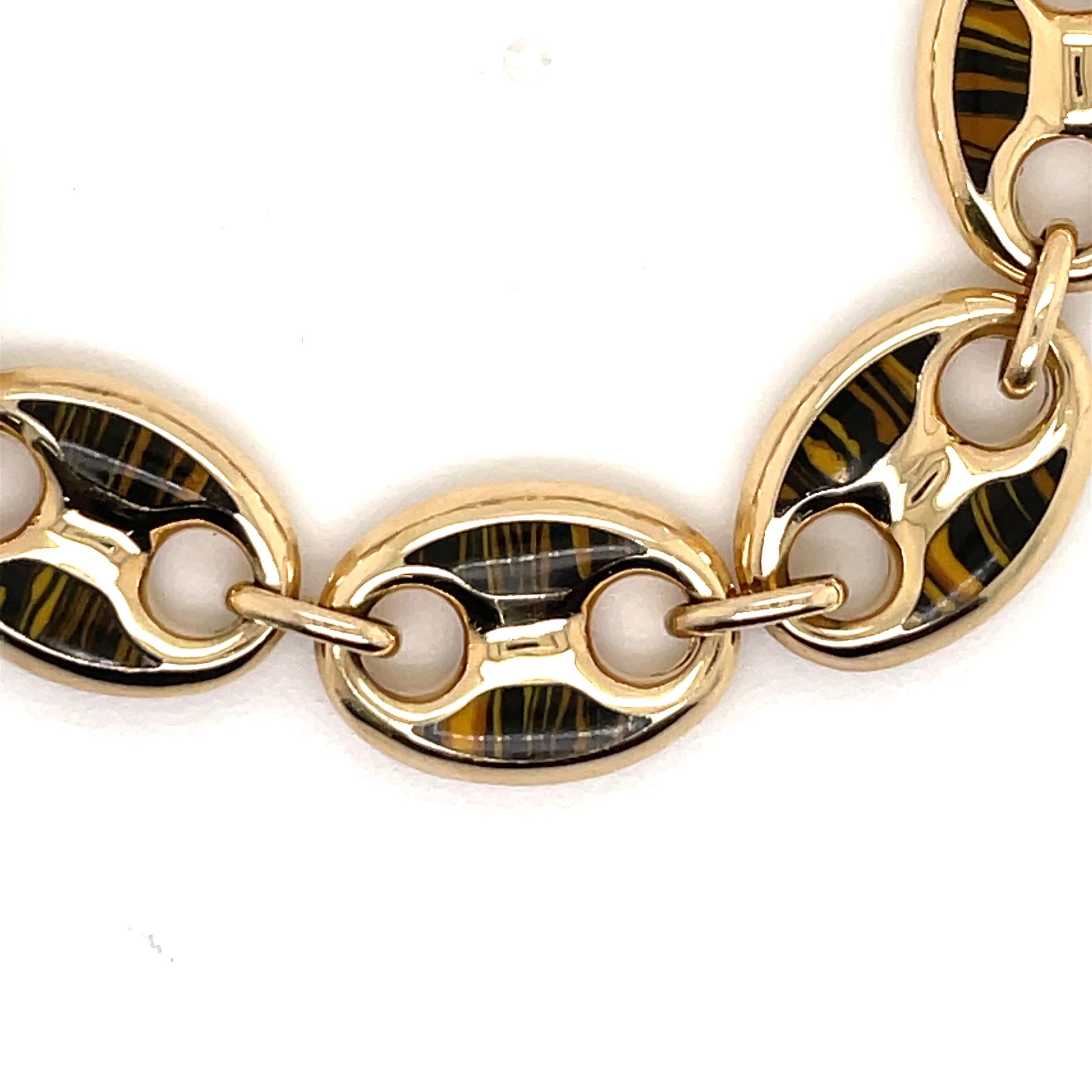 Made in Italy, this mariner link bracelet features 9 tiger eye links over 14 karat yellow gold.
Very Chic & great for stacking.
Available in Green, Black, Red, Pink, & Blue.
Available in single links on gold chain or leather cord.
Email for more