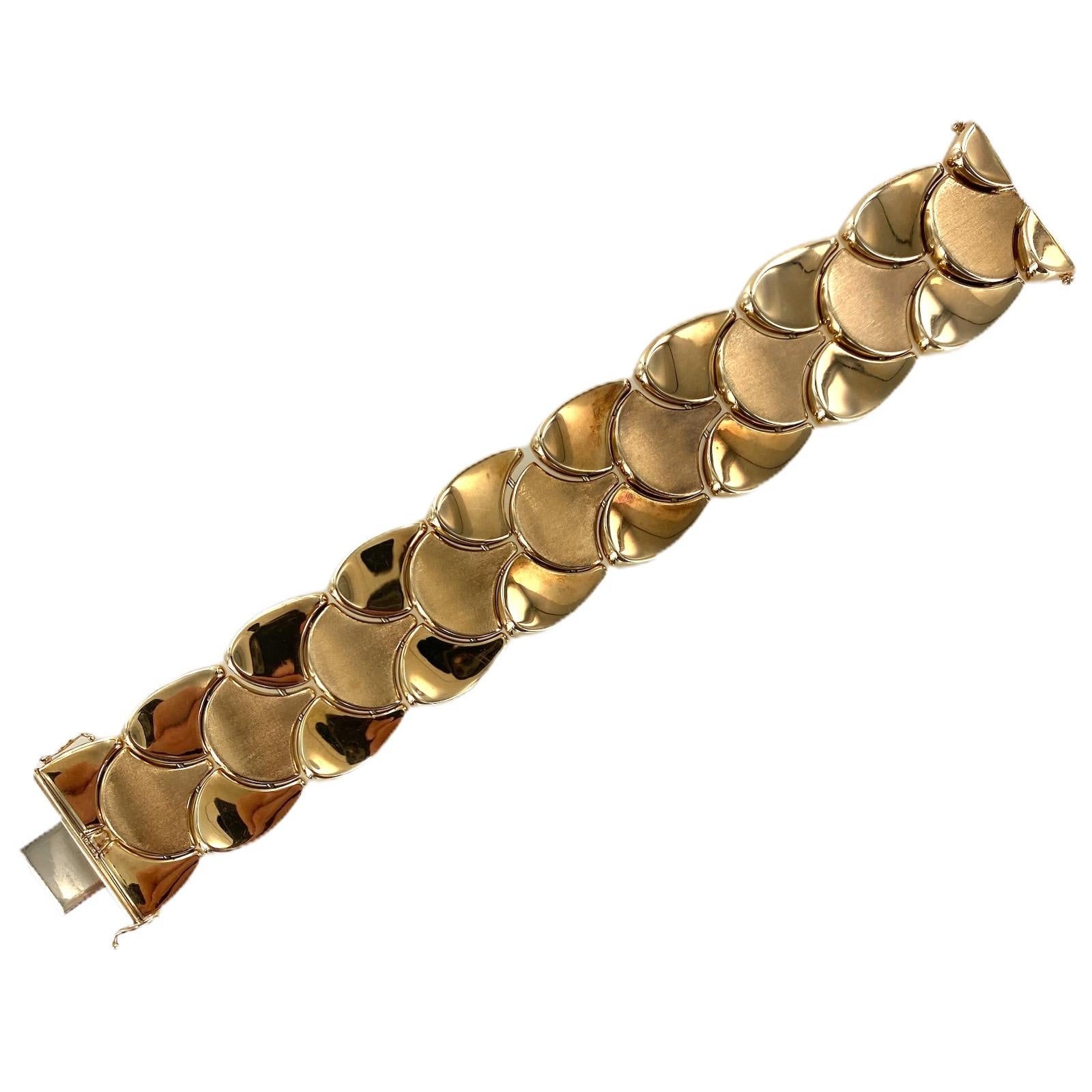 Italian wide link vintage bracelet fashioned in polished and satin finished 14 karat yellow gold. The bracelet measures 7.25 inches in length and 1.0 inch in width. 