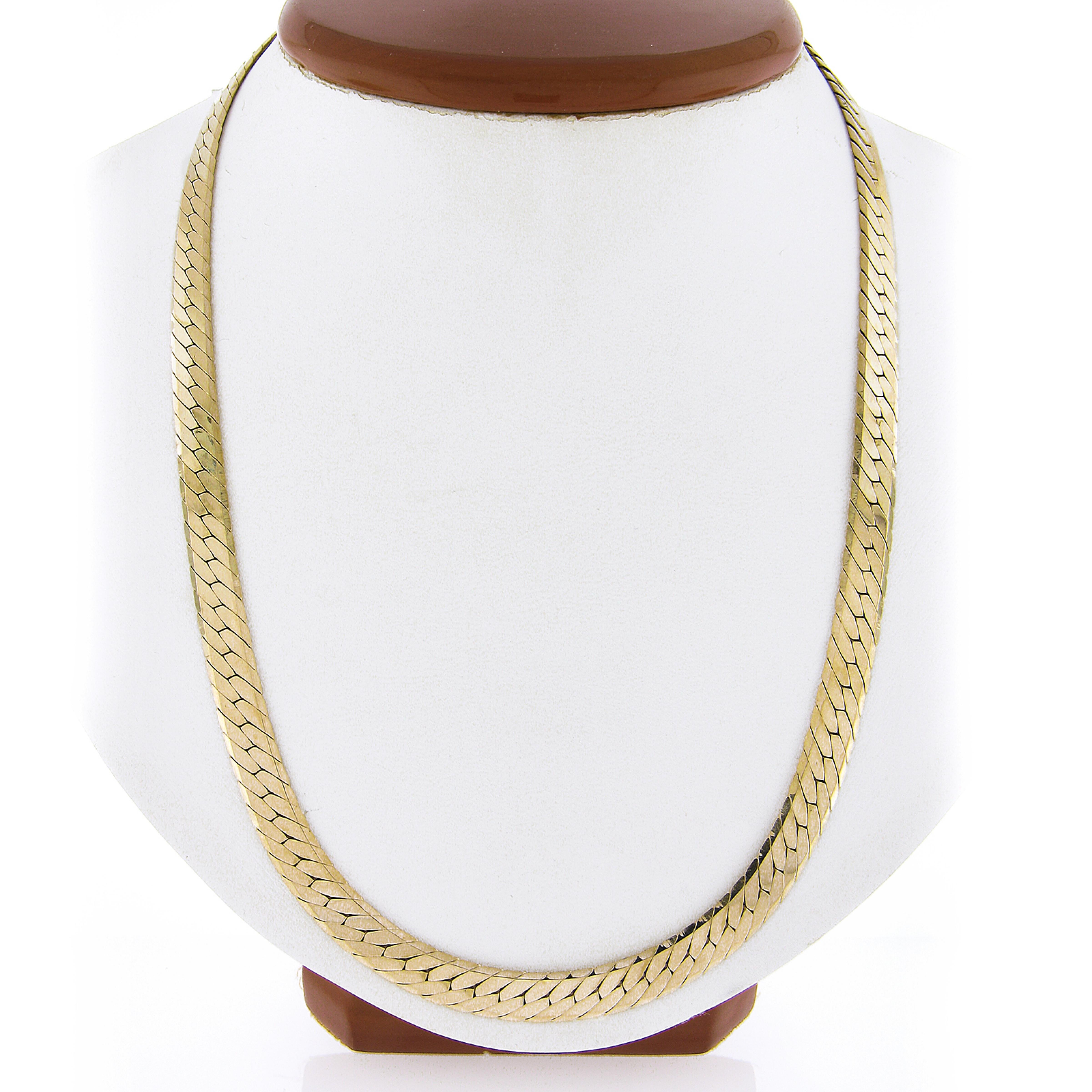 This gorgeous and very well made chain necklace was crafted in Italy from solid 14k yellow gold and features a fancy, flat, herringbone snake link with a super high-polished finish throughout that gives this piece a very attractive and super shiny