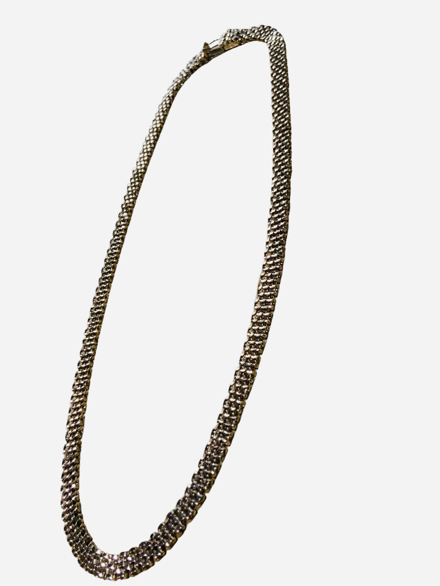 This is a Lady’s panther necklace in 14K yellow gold. Its length is 18 inches and width is 6.33 mm. The necklace contains a hidden box clasp with one eight figure safety. It weighs 26.7grams. It is signed 585, Italy in the clasp box.