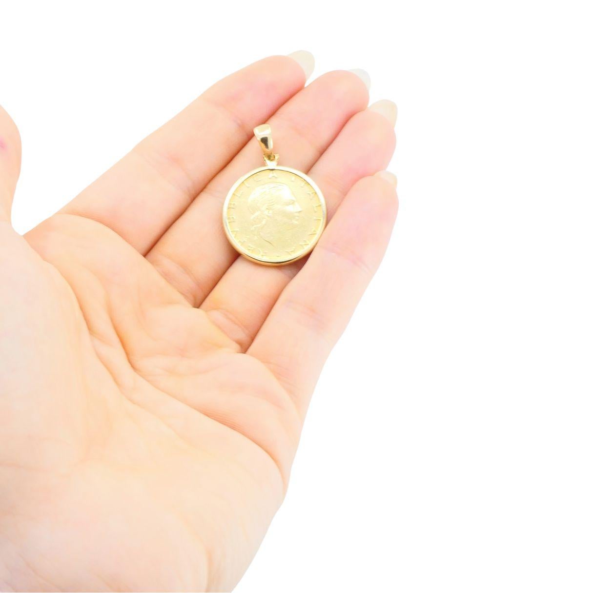 This vintage Italian pendant features an authentic 1978 200 Lire coin, set in a finely crafted 14K yellow gold bezel by Milor. The coin itself is composed of aluminum-bronze, displaying the elegant profile of Italia designed by Mario Vallucci,
