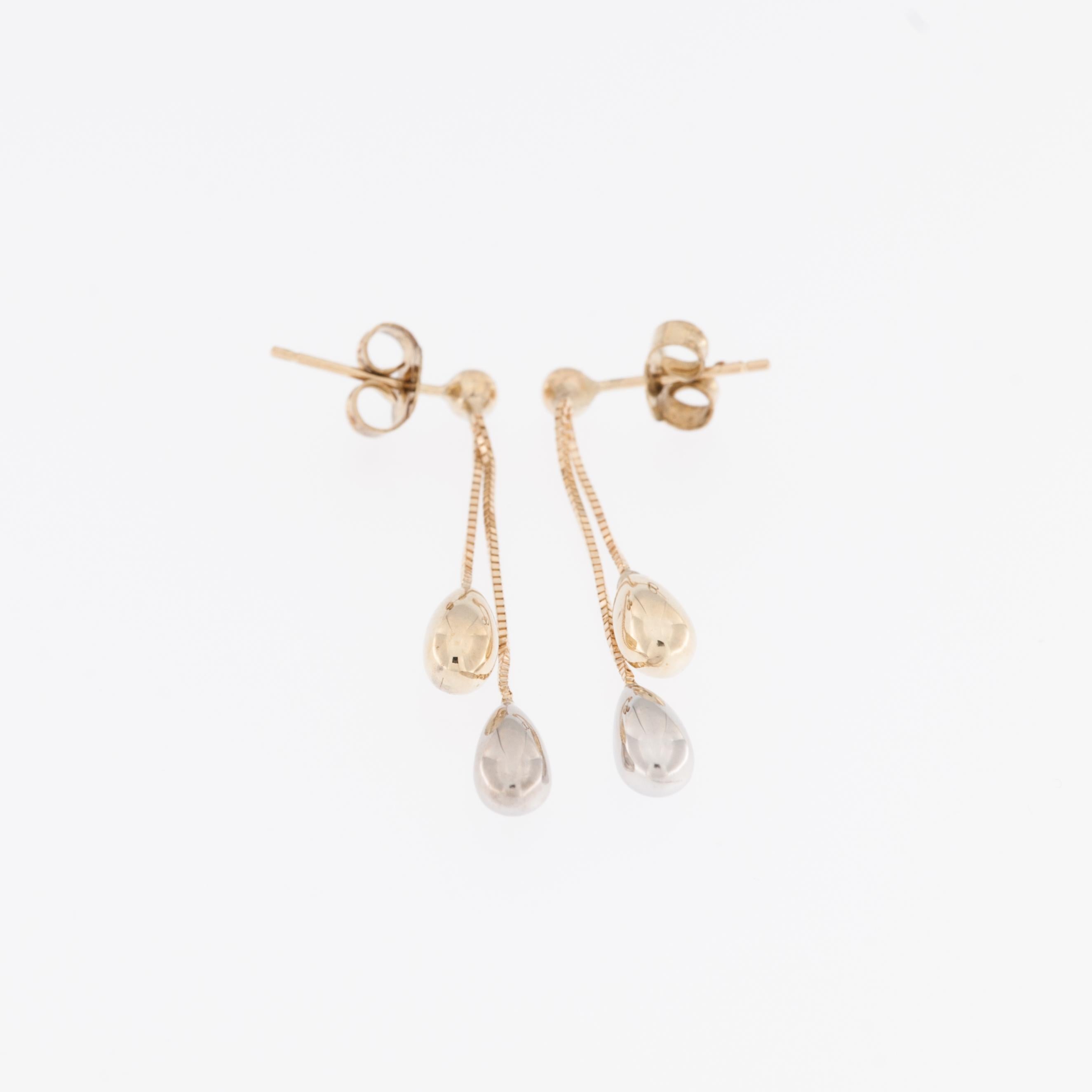 The Italian 14kt Yellow and White Gold Drop Earrings are an elegant piece of jewelry that combines two precious metals to create a captivating design. 

These earrings are crafted from high-quality Italian 14-karat (14kt) gold, which is known for