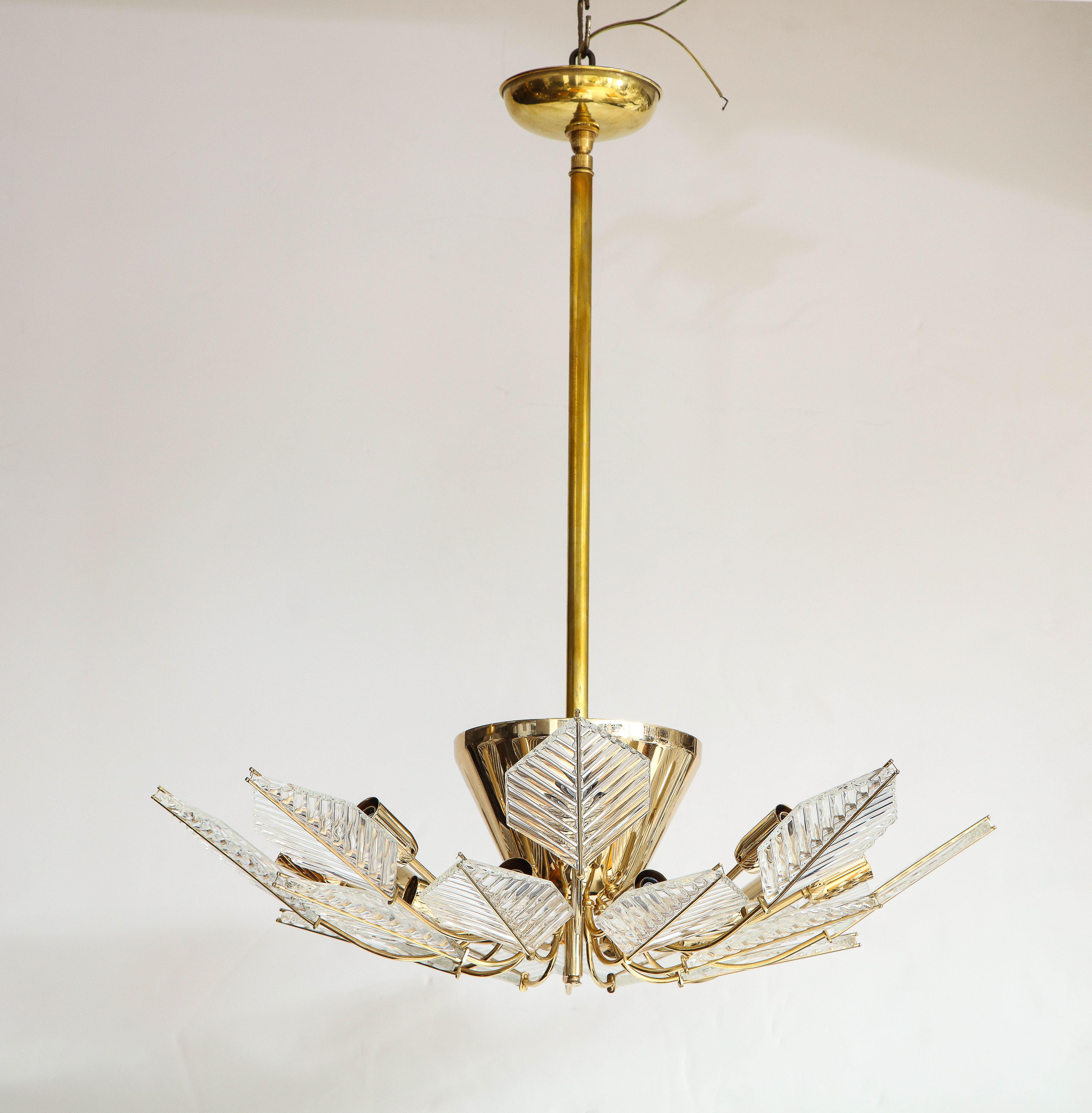 An Italian vintage chandelier with 15 lights, the gold plated stem and central support attach to the 15 arms decorated with cut glass leaf pattern design which support the lights underneath and for which provide a beautiful warm glow. An elegant and