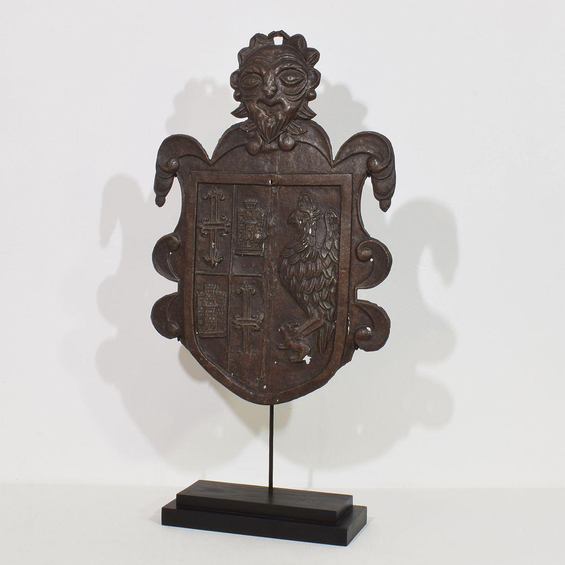 Unique and wonderful folk art coat of arms, Depicting a eagle holding a rabbit, two crosses and two castle's and on the top a grotesque head. This beautiful period piece is made out of forged iron and comes from the region of Florence. Due to its