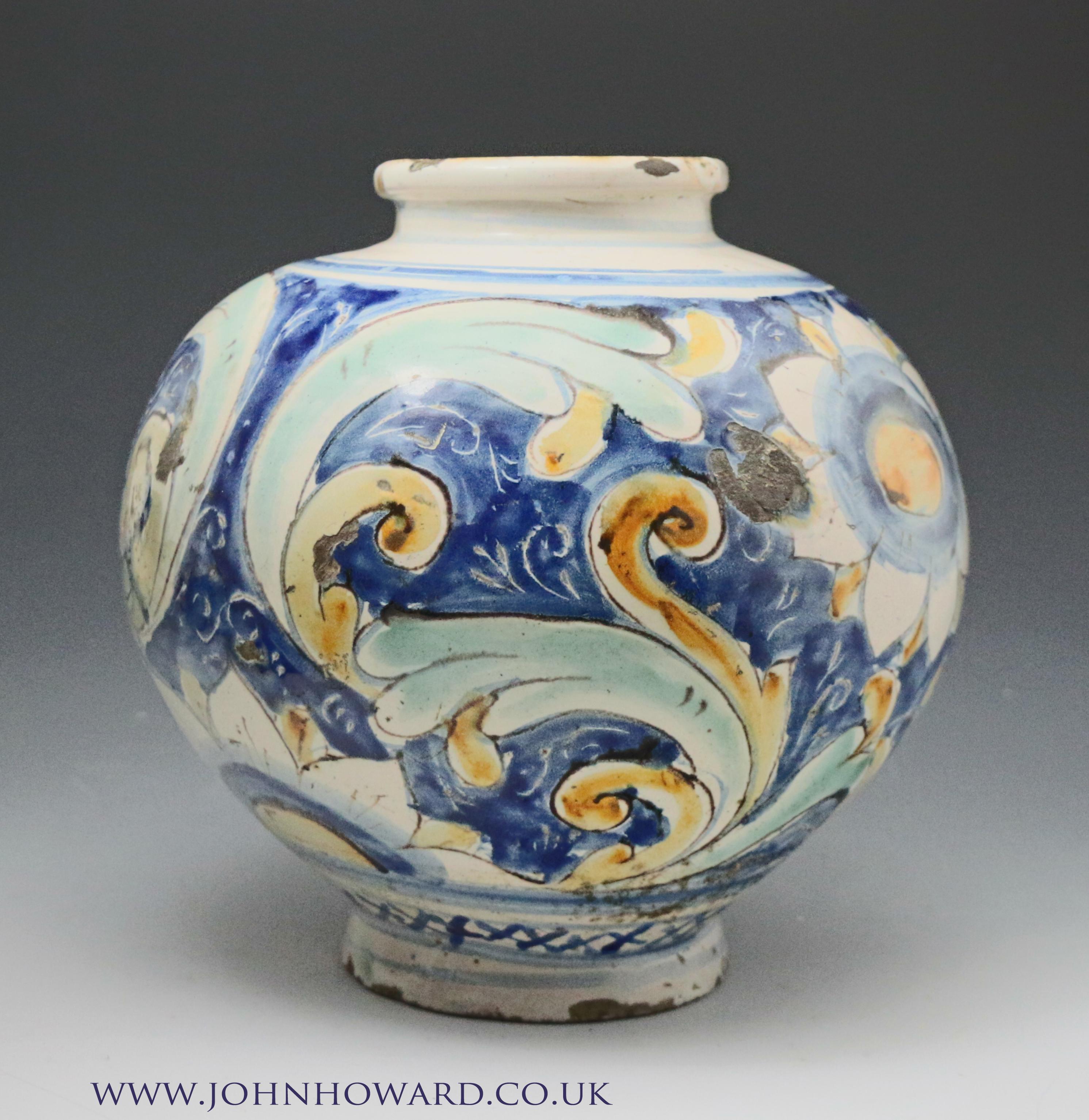 A caltagirone pottery earthenware maiolica jar, 16th century.
Boldly painted with flowers and scrolling foliage on a blue ground, blue borders to the rims, probably a pharmacy vessel. The maiolica color decoration of turquoise, ochre and blue are