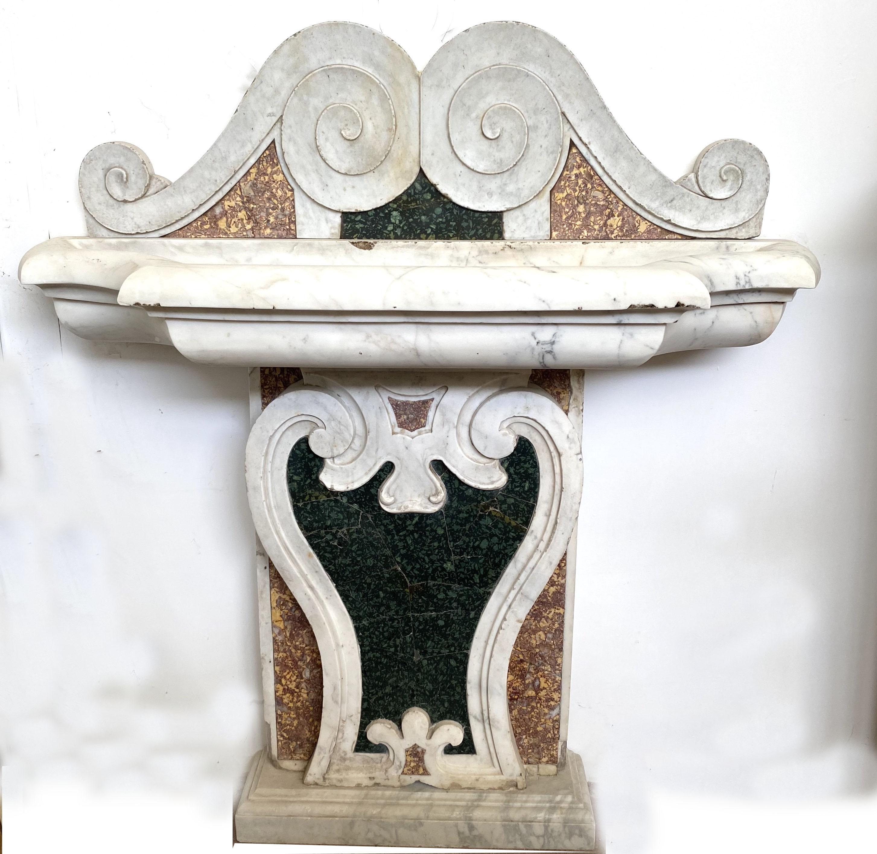 Fabulous Italian 17th century Baroque marble fountain with Serpentine green, white Carrara and Brocatello di Spagna marbles inlays.

Three piece set composed of a base, front and shaped White marble vasca to be placed on a wall.

We can arrange