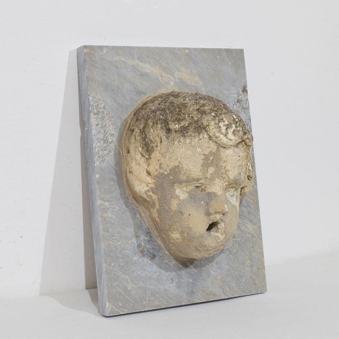 Barocco Testa di fontana di cherubino in pietra intagliata del XVII-XVIII secolo su pannello di marmo in vendita