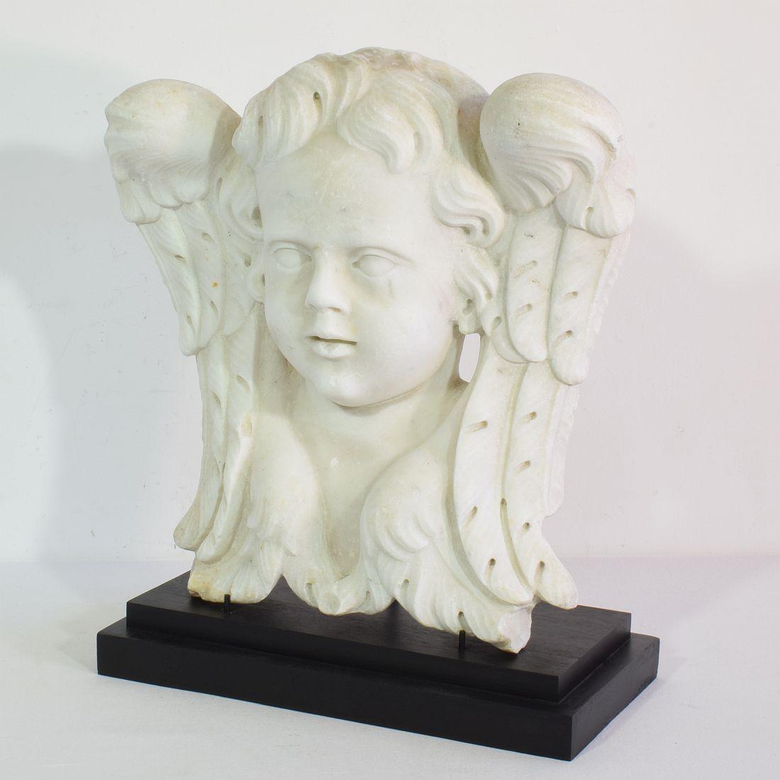 Beautiful and unique handcarved white marble winged angel head ornament that once adorned a facade.
Italy, circa 1650-1750.
Weathered and small losses.
Measurement includes the wooden base.