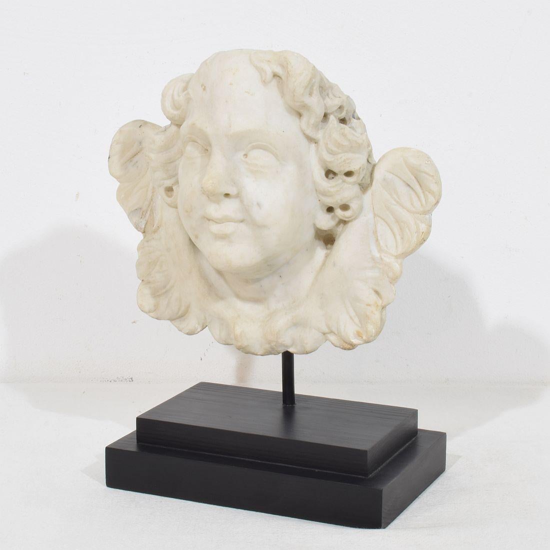Beautiful and unique handcarved white marble winged angel head ornament that once adorned a facade.
Italy, circa 1650-1750.
Weathered and small losses and old repairs/ restorations ( on the wings).
Measurement includes the wooden base.
H:28,5cm 