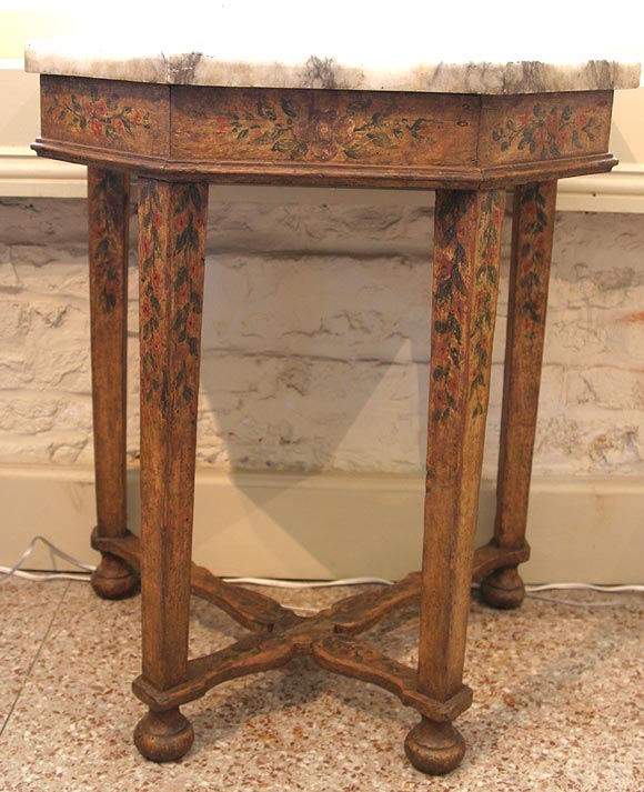 An Italian Baroque painted console with the original grey and white marble top. The sides, four legs and X-shaped stretcher are detailed with flowers and leaves.