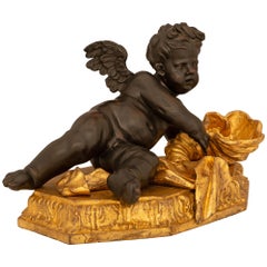 Italian 17th Century Baroque Period Giltwood And Patinated Wood Putti Statue