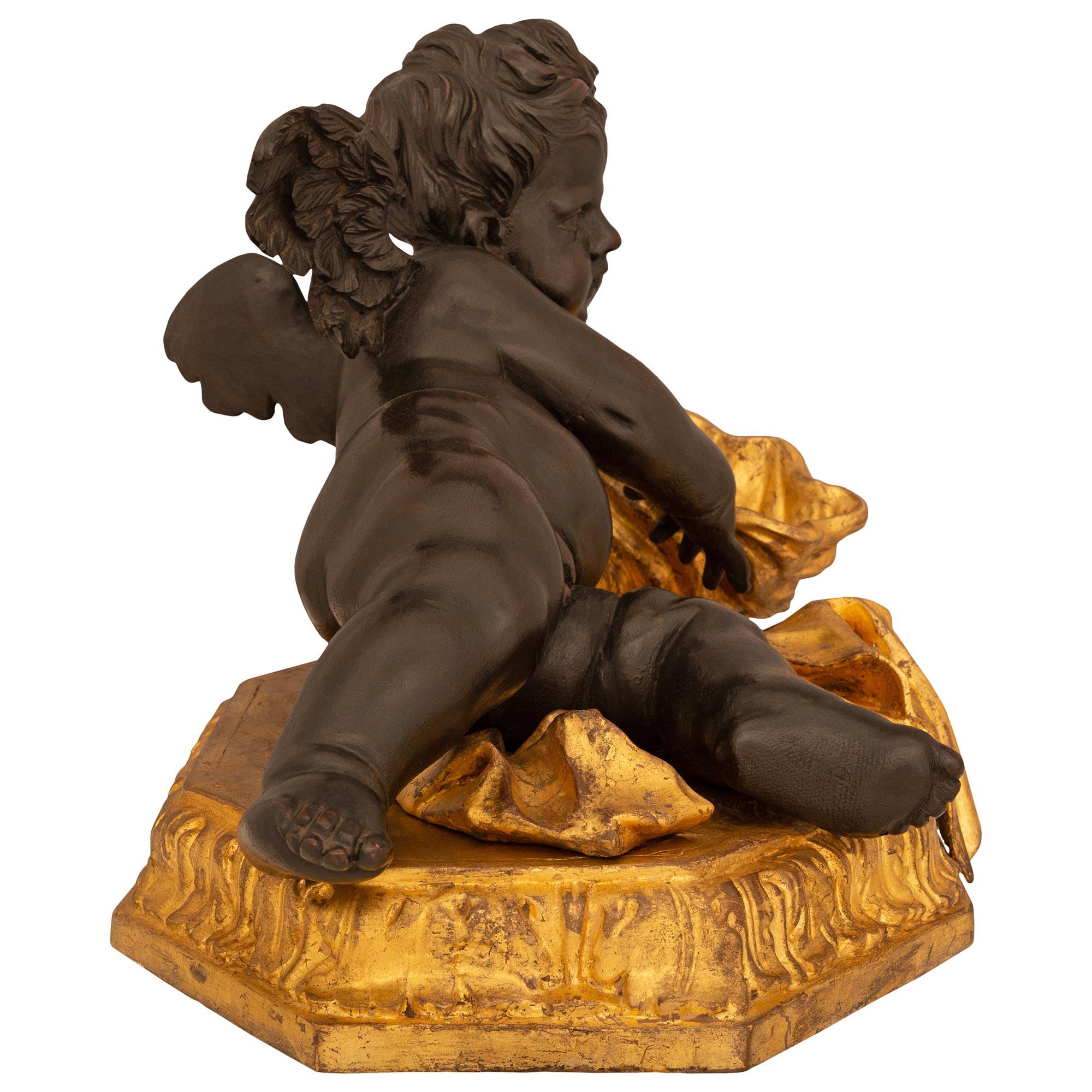 Italian 17th Century Baroque Period Giltwood And Patinated Wood Putti Statue In Good Condition For Sale In West Palm Beach, FL